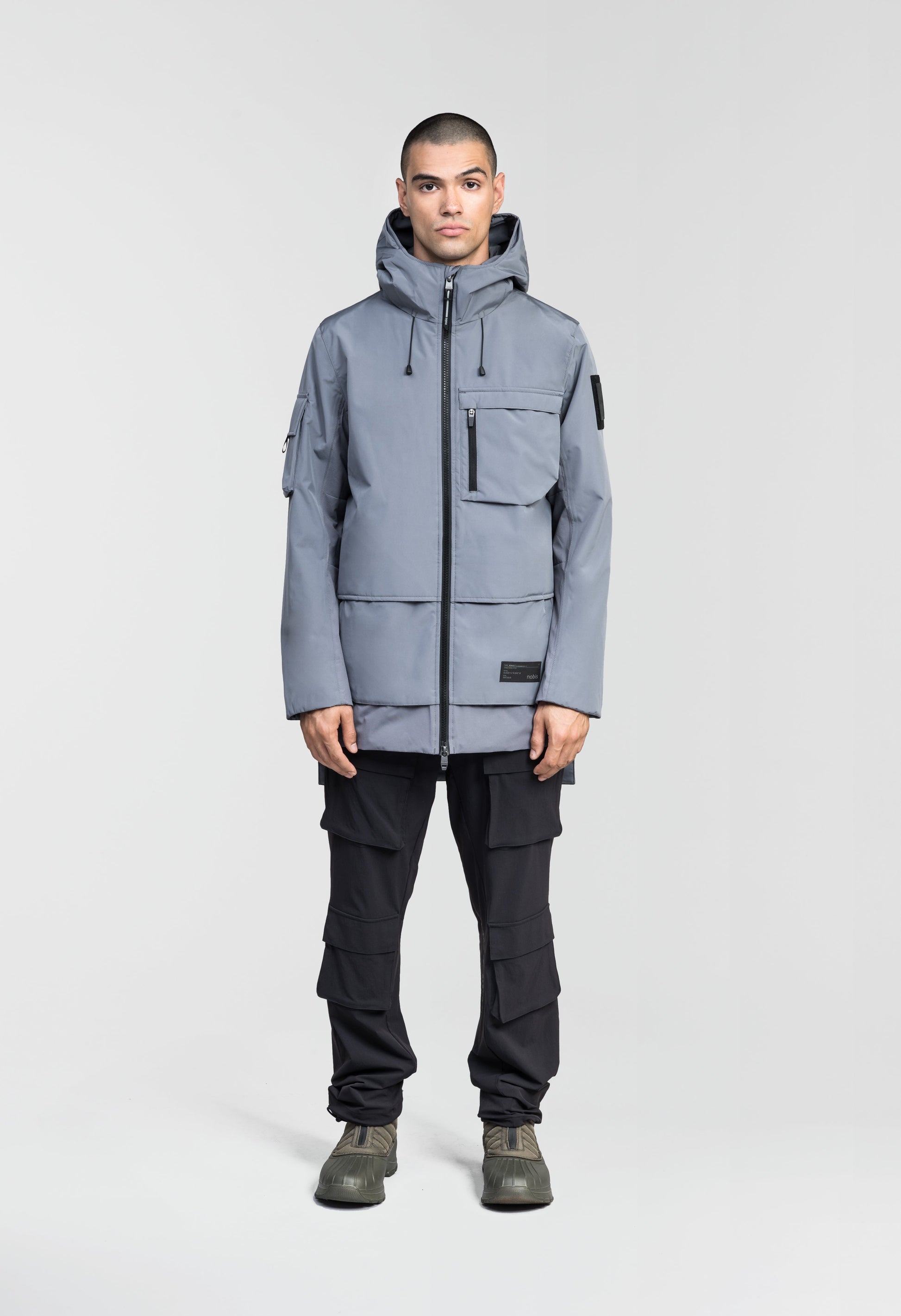 Alta Men's Performance Shell Jacket in hip length, Primaloft Gold Insulation Active+, chest and waist pockets, ventilation under arms, reflective detailing on hood and back, two-way front zipper, and non-removable hood with adjustable drawstrings, in Concrete