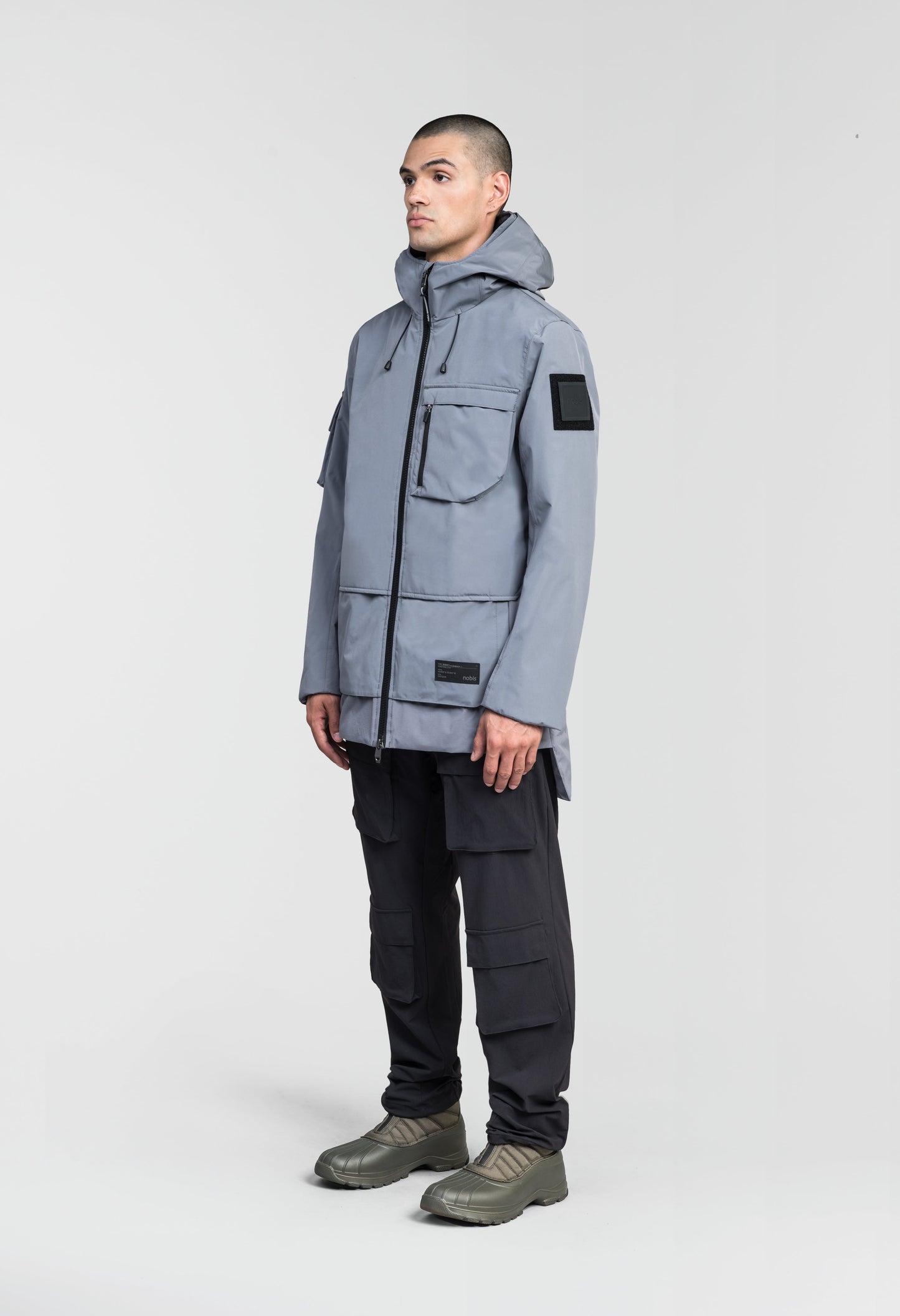 Alta Men's Performance Shell Jacket in hip length, Primaloft Gold Insulation Active+, chest and waist pockets, ventilation under arms, reflective detailing on hood and back, two-way front zipper, and non-removable hood with adjustable drawstrings, in Concrete