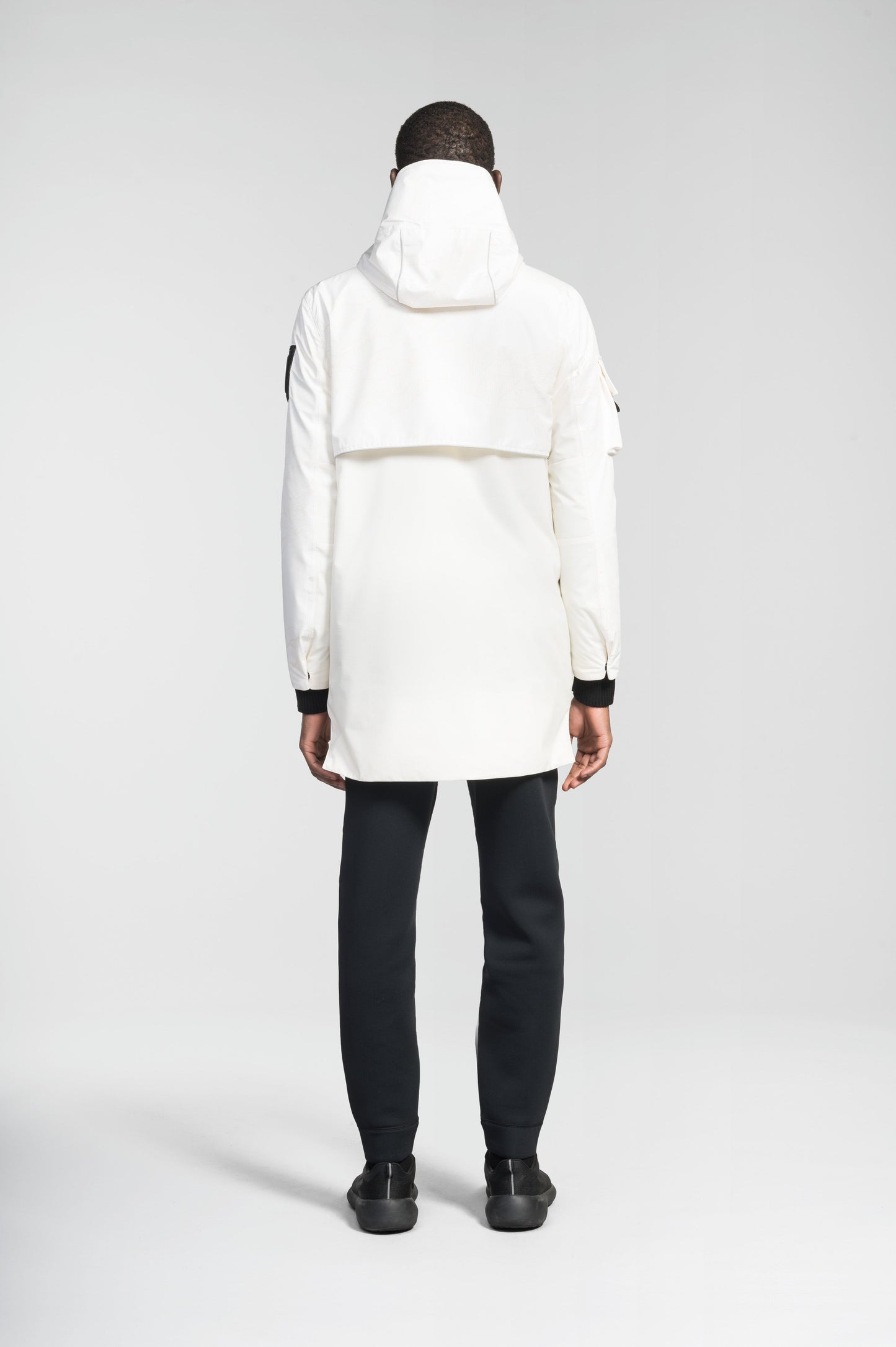 Alta Men's Performance Shell Jacket in hip length, Primaloft Gold Insulation Active+, chest and waist pockets, ventilation under arms, reflective detailing on hood and back, two-way front zipper, and non-removable hood with adjustable drawstrings, in Wheat Desert