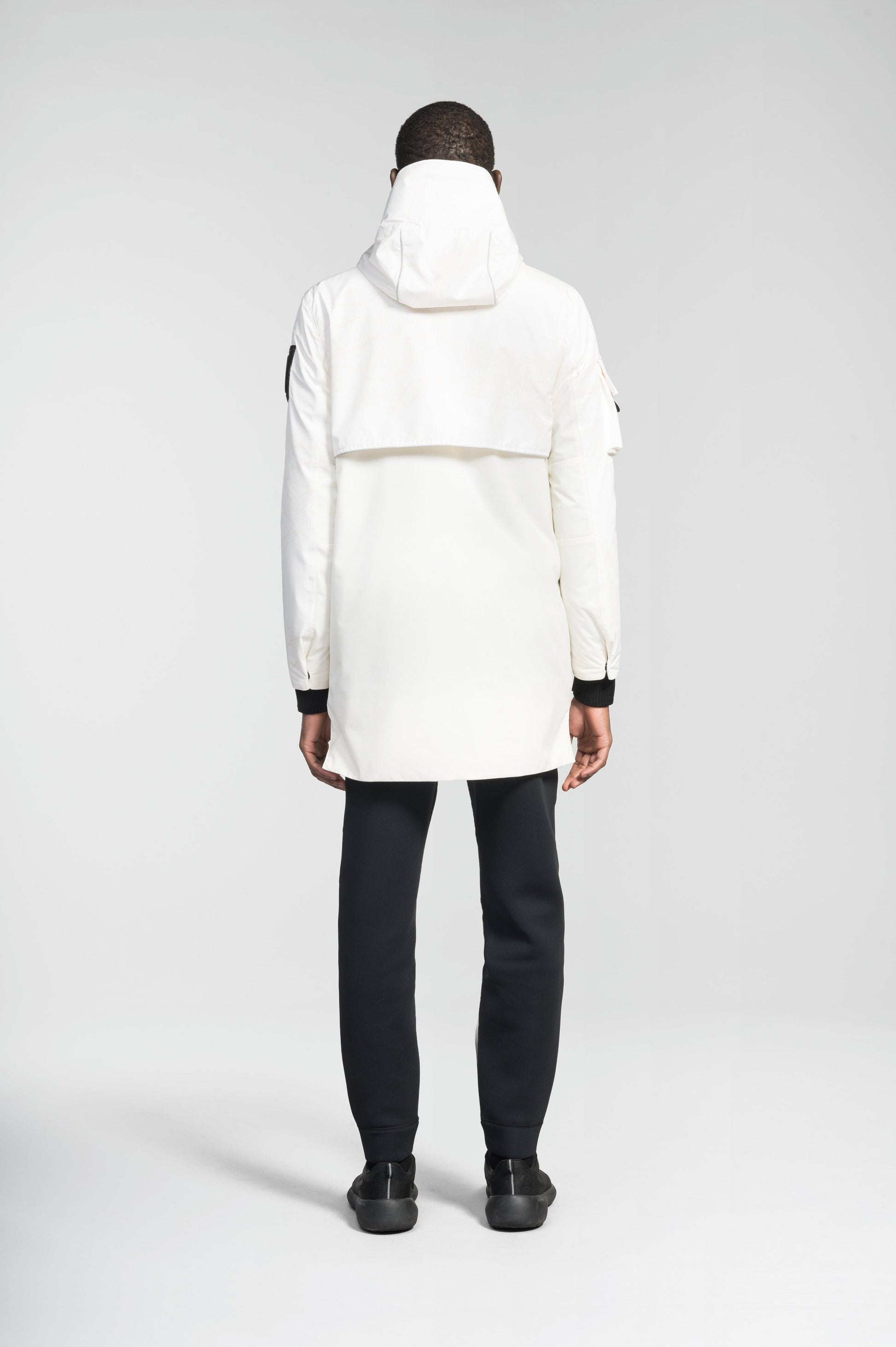 Alta Men's Performance Shell Jacket in hip length, Primaloft Gold Insulation Active+, chest and waist pockets, ventilation under arms, reflective detailing on hood and back, two-way front zipper, and non-removable hood with adjustable drawstrings, in Wheat Desert