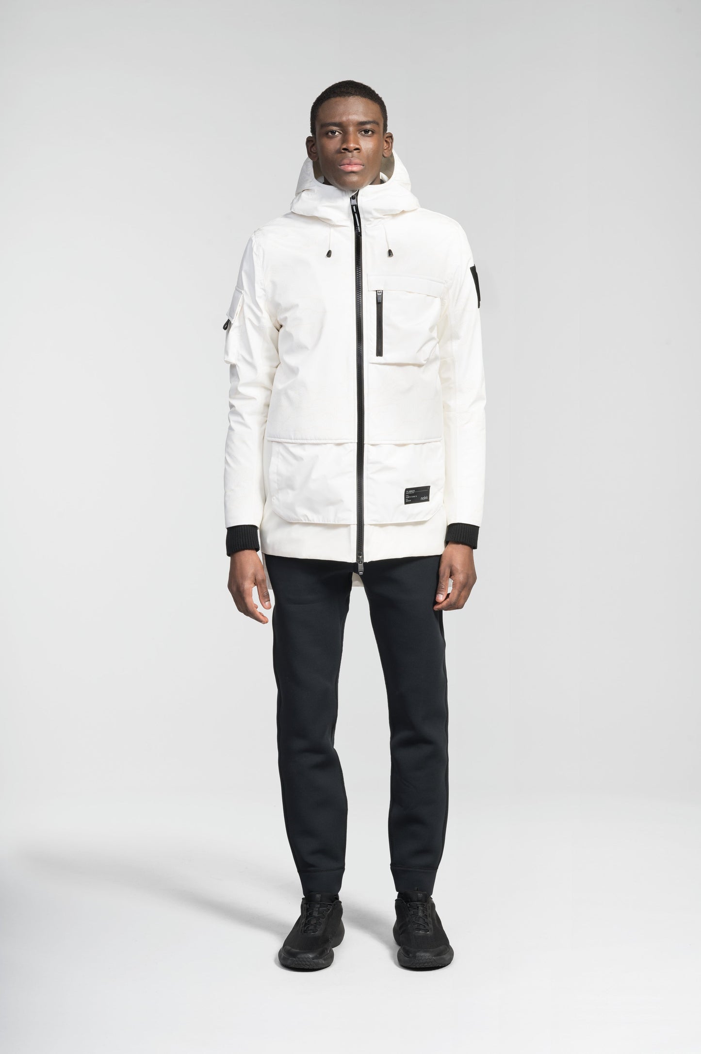 Alta Men's Performance Shell Jacket in hip length, Primaloft Gold Insulation Active+, chest and waist pockets, ventilation under arms, reflective detailing on hood and back, two-way front zipper, and non-removable hood with adjustable drawstrings, in Wheat Desert