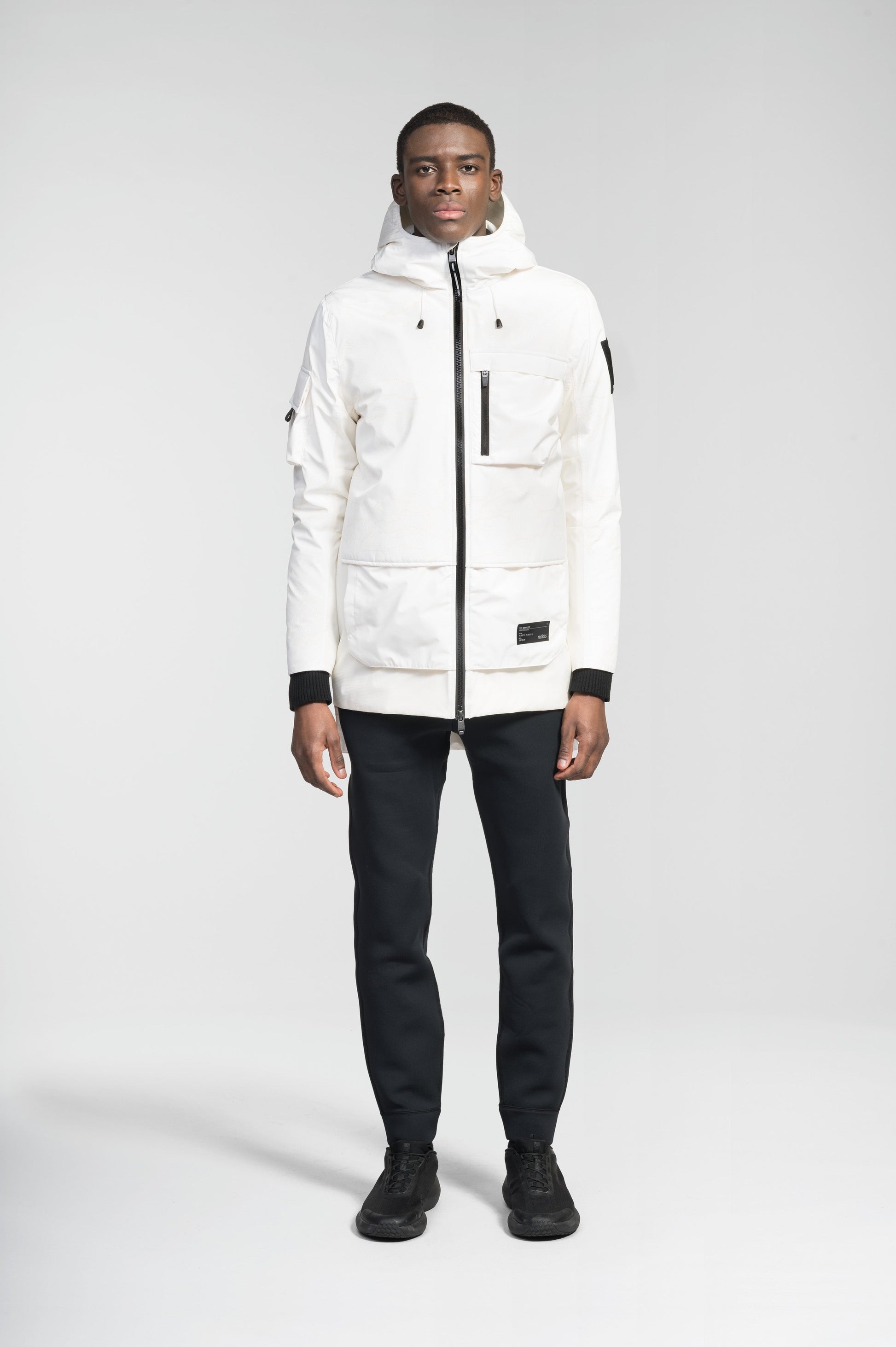 Alta Men's Performance Shell Jacket in hip length, Primaloft Gold Insulation Active+, chest and waist pockets, ventilation under arms, reflective detailing on hood and back, two-way front zipper, and non-removable hood with adjustable drawstrings, in Wheat Desert