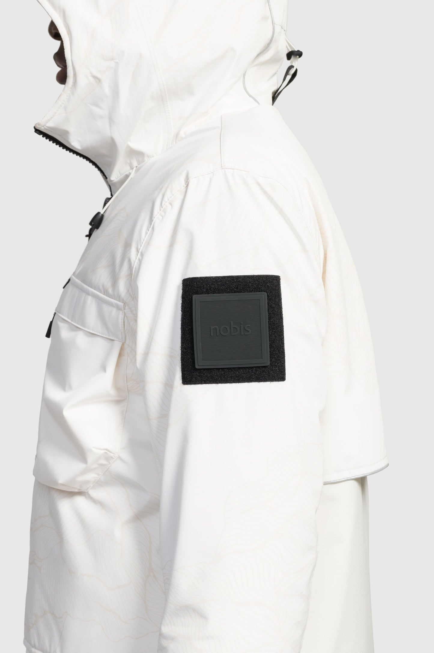 Alta Men's Performance Shell Jacket in hip length, Primaloft Gold Insulation Active+, chest and waist pockets, ventilation under arms, reflective detailing on hood and back, two-way front zipper, and non-removable hood with adjustable drawstrings, in Wheat Desert