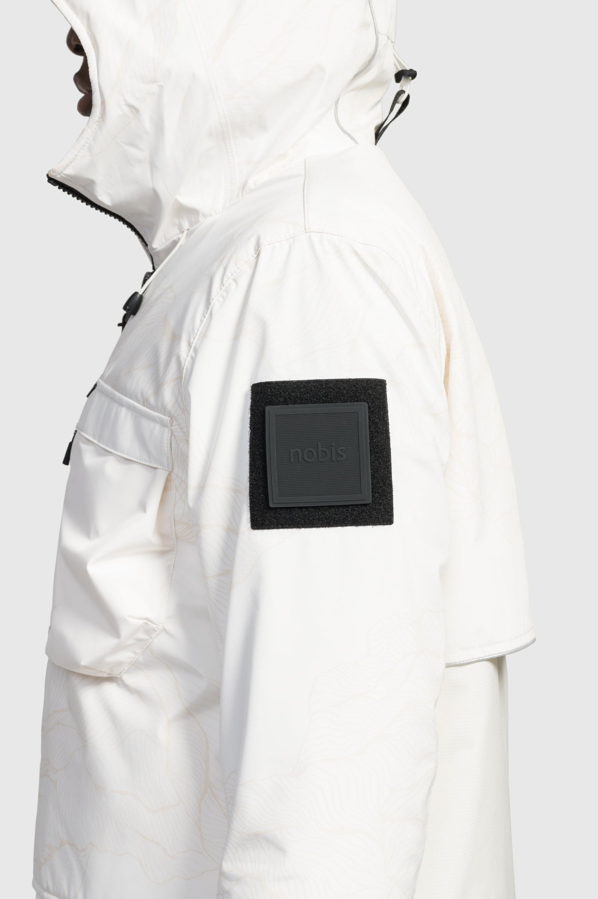 Alta Men's Performance Shell Jacket in hip length, Primaloft Gold Insulation Active+, chest and waist pockets, ventilation under arms, reflective detailing on hood and back, two-way front zipper, and non-removable hood with adjustable drawstrings, in Wheat Desert