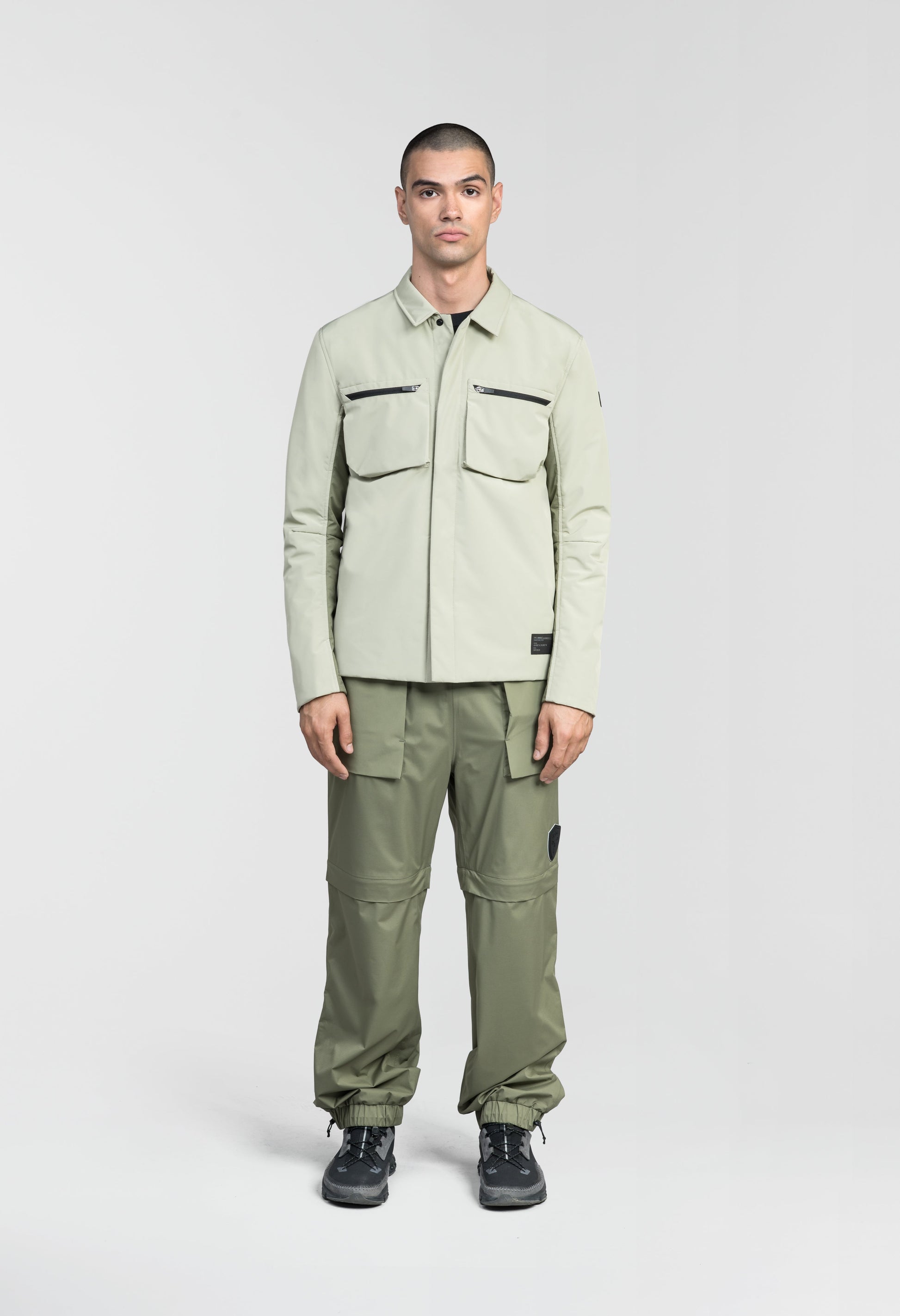 Ander Men's Mid Layer Shirt in hip length, PrimaLoft Gold Insulation Active+, 3-Ply Micro Denier front and 4-Way Durable Stretch Weave back, zipper chest pockets, snap button wind flap, and snap button cuffs, in Tea/Clover