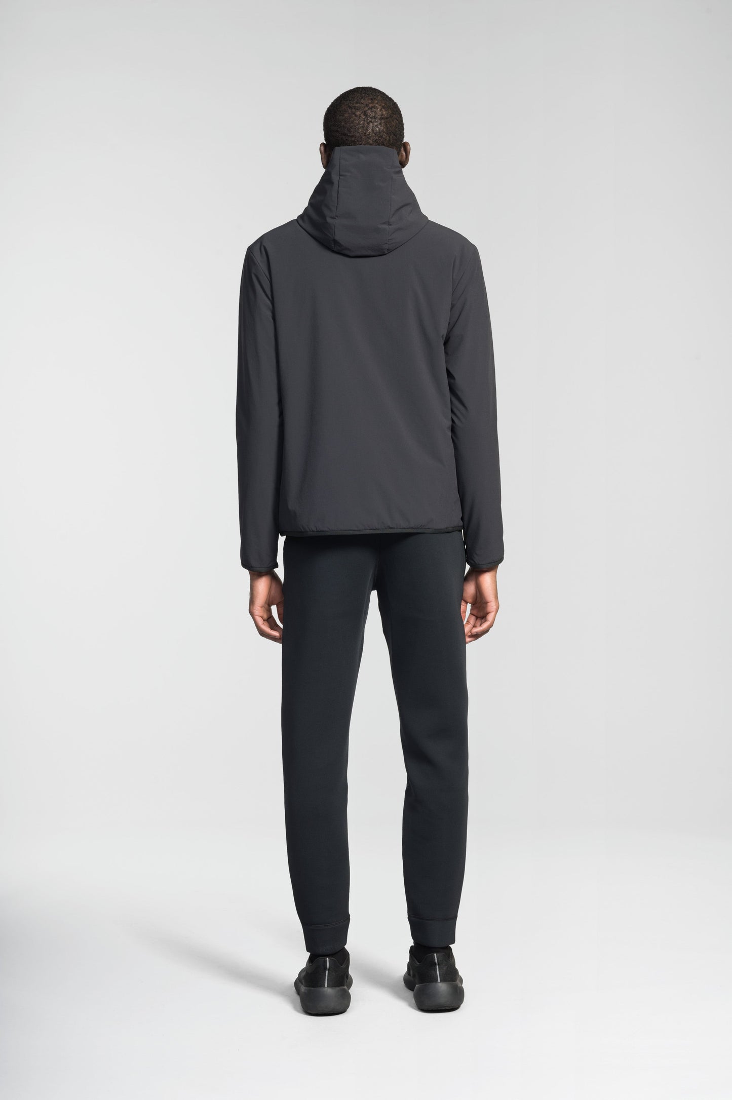 Men's hip length mid layer jacket with non-removable hood and two-way zipper in Black