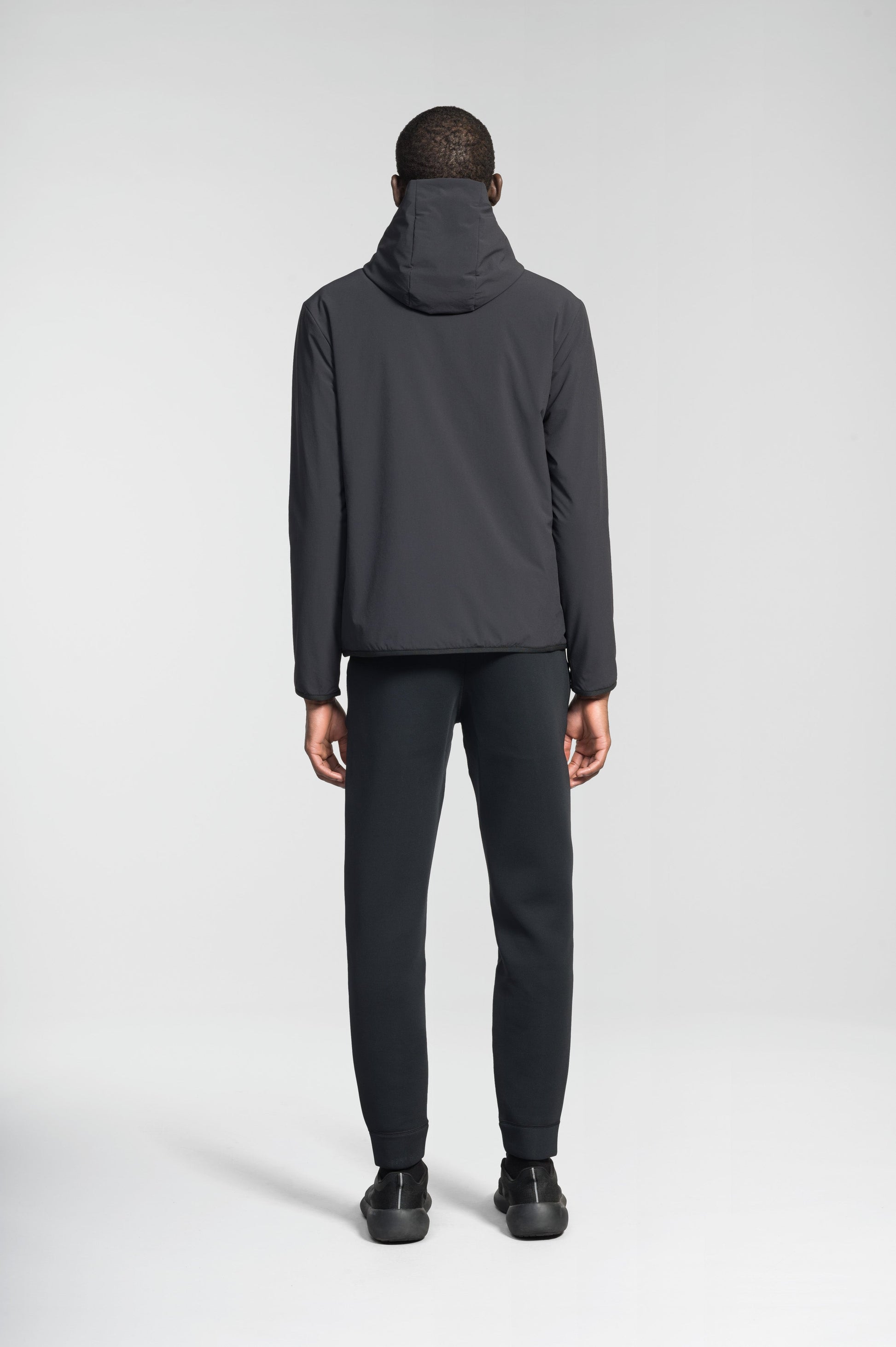 Men's hip length mid layer jacket with non-removable hood and two-way zipper in Black