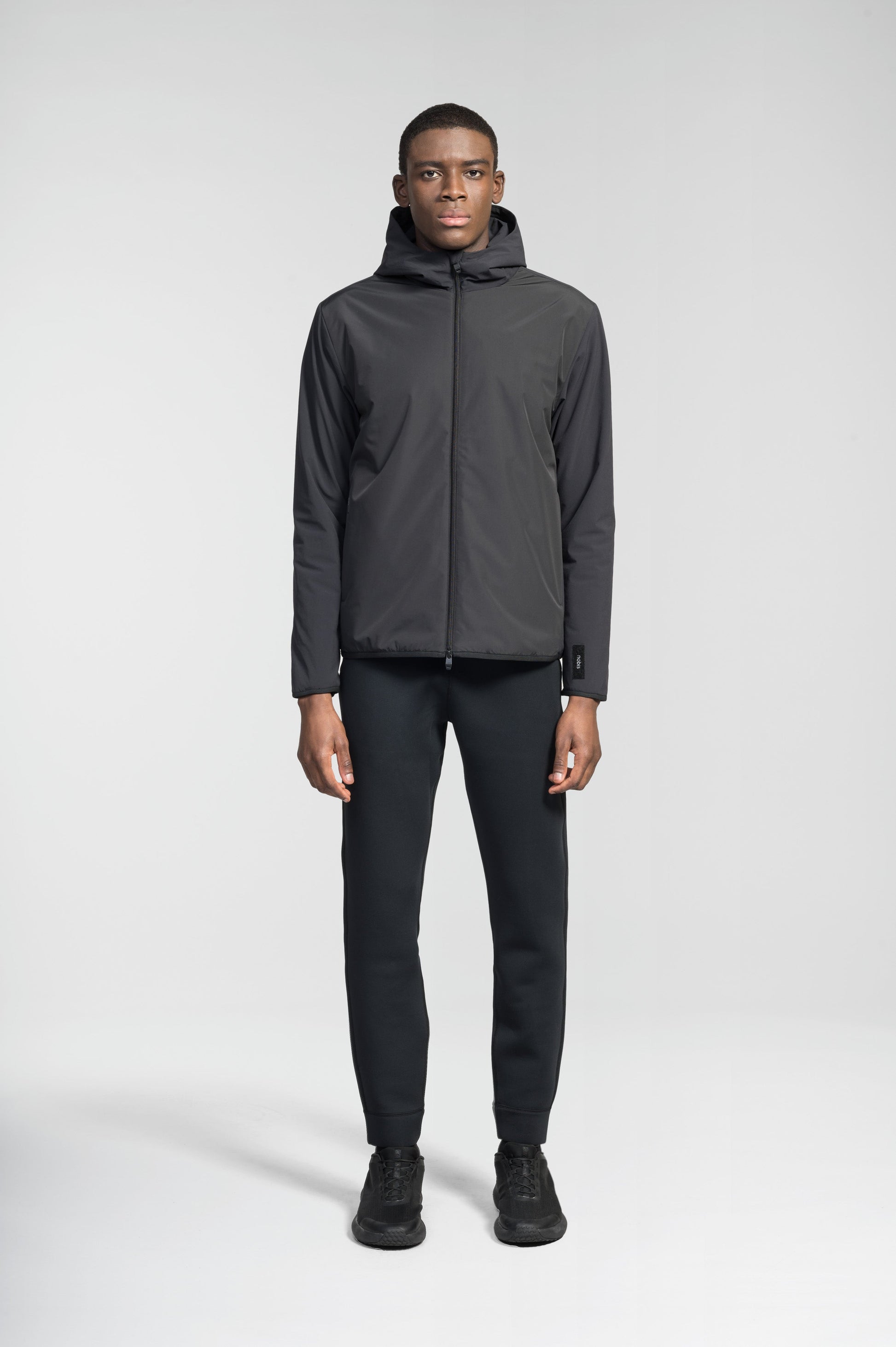 Men's hip length mid layer jacket with non-removable hood and two-way zipper in Black