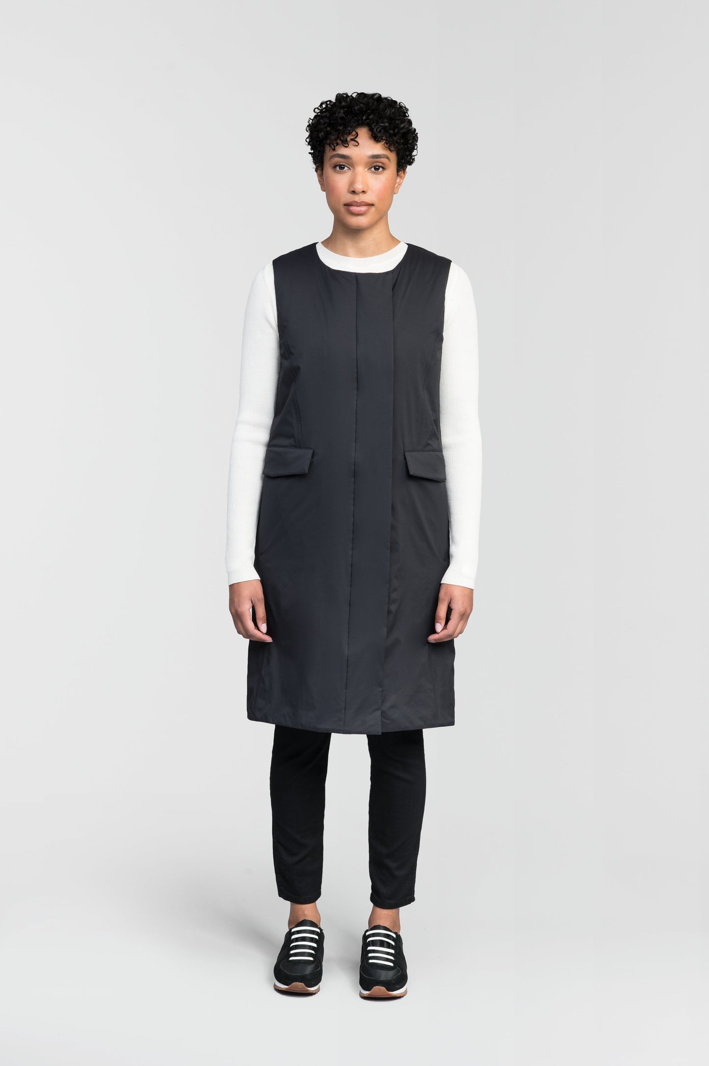 Brexton Women's Tailored Long Mid Layer Vest in knee length, centre front wind flap, flap closure waist pocket with additional side entry storage, single vent on back bottom hem, in Black