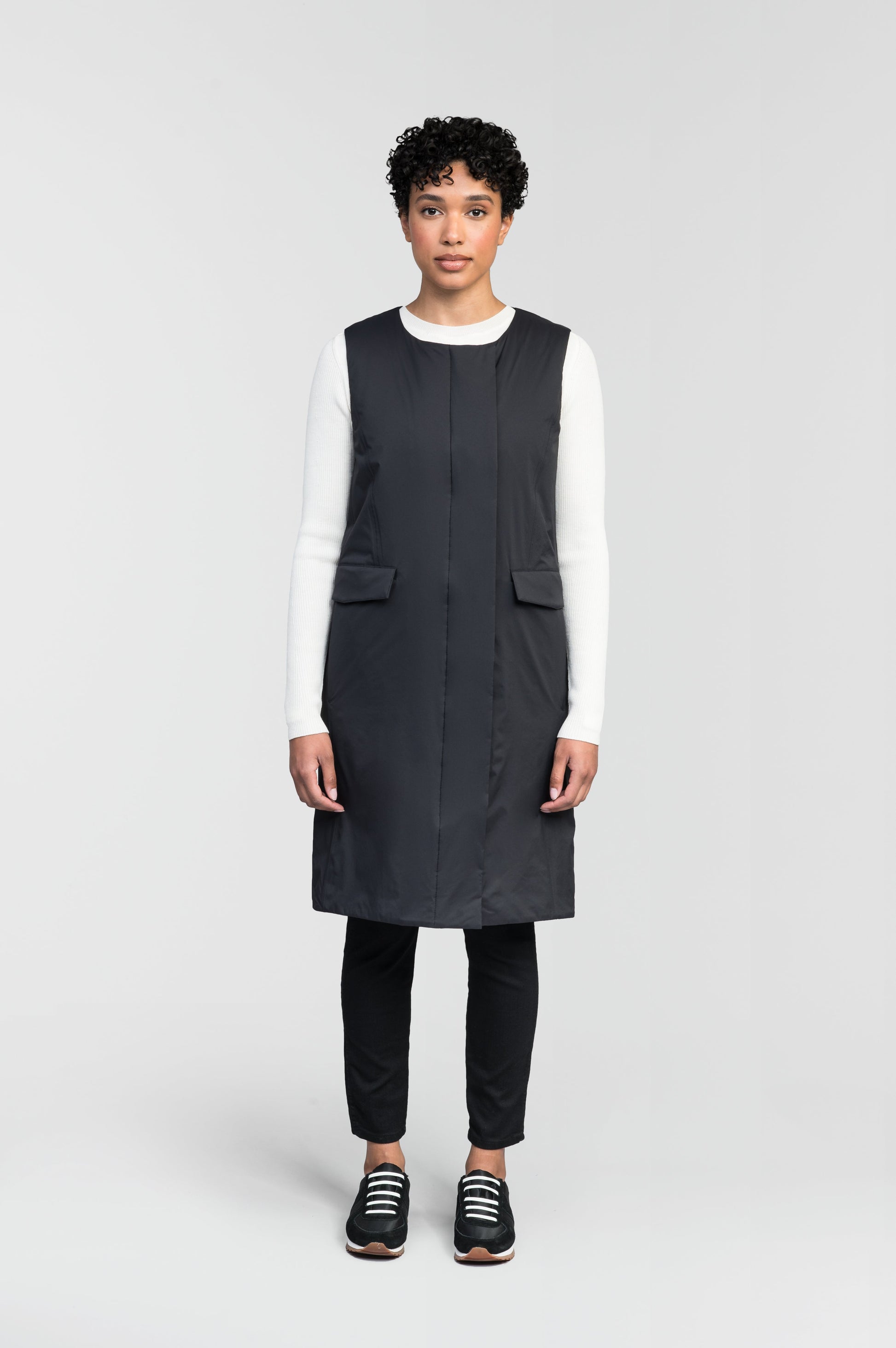 Brexton Women's Tailored Long Mid Layer Vest in knee length, centre front wind flap, flap closure waist pocket with additional side entry storage, single vent on back bottom hem, in Black