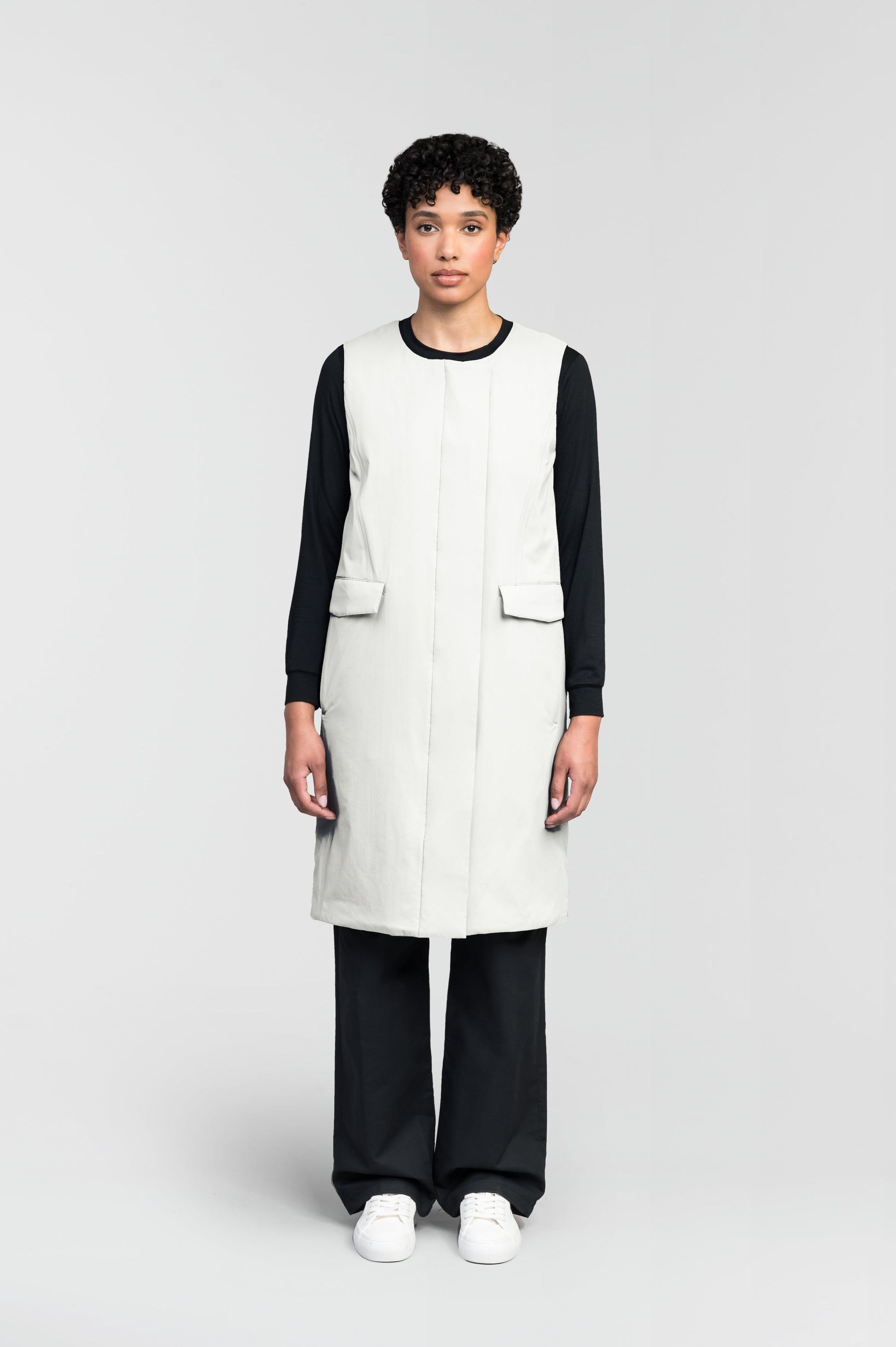 Brexton Women's Tailored Long Mid Layer Vest in knee length, centre front wind flap, flap closure waist pocket with additional side entry storage, single vent on back bottom hem, in Chalk