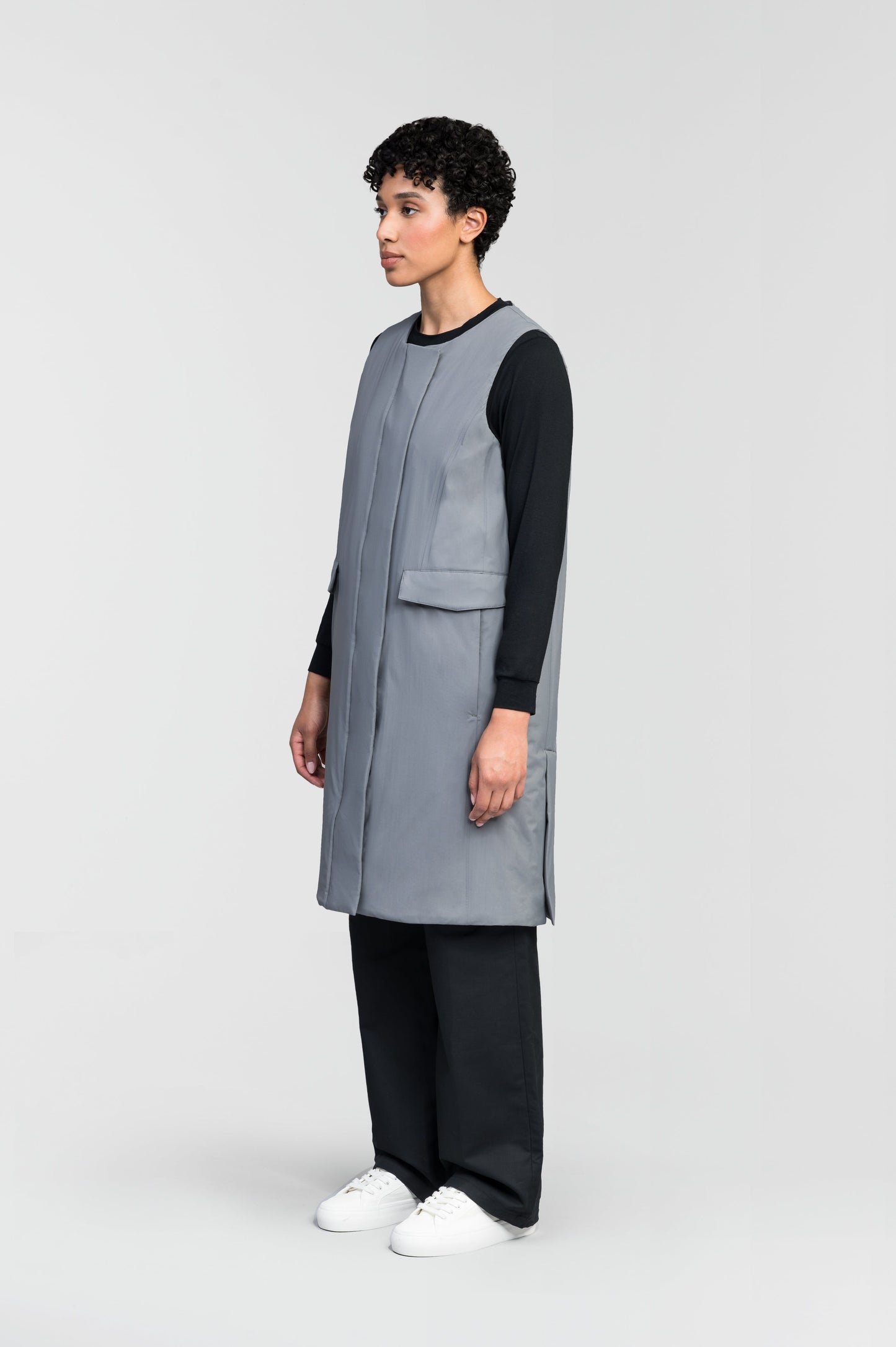 Brexton Women's Tailored Long Mid Layer Vest in knee length, centre front wind flap, flap closure waist pocket with additional side entry storage, single vent on back bottom hem, in Concrete