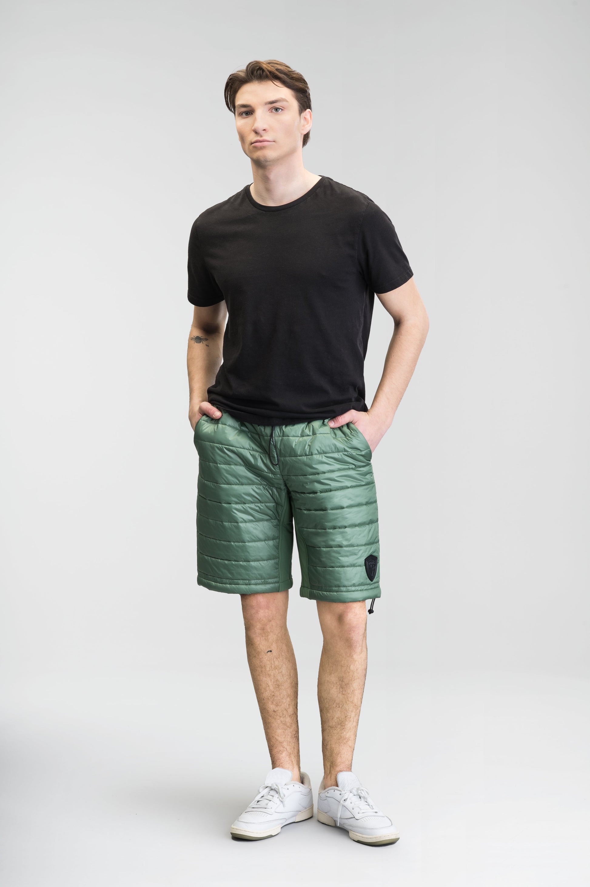 Decker Men's Performance Quilted Shorts in knee length, premium cire technical nylon taffeta and stretch nylon fabrication, premium 4-way stretch, water-resistant Primaloft Gold Insulation Active+, side seam pockets, invisible zipper back pokcet, elasticized waist with drawcords, and hidden drawcord at leg hems, in Comfrey
