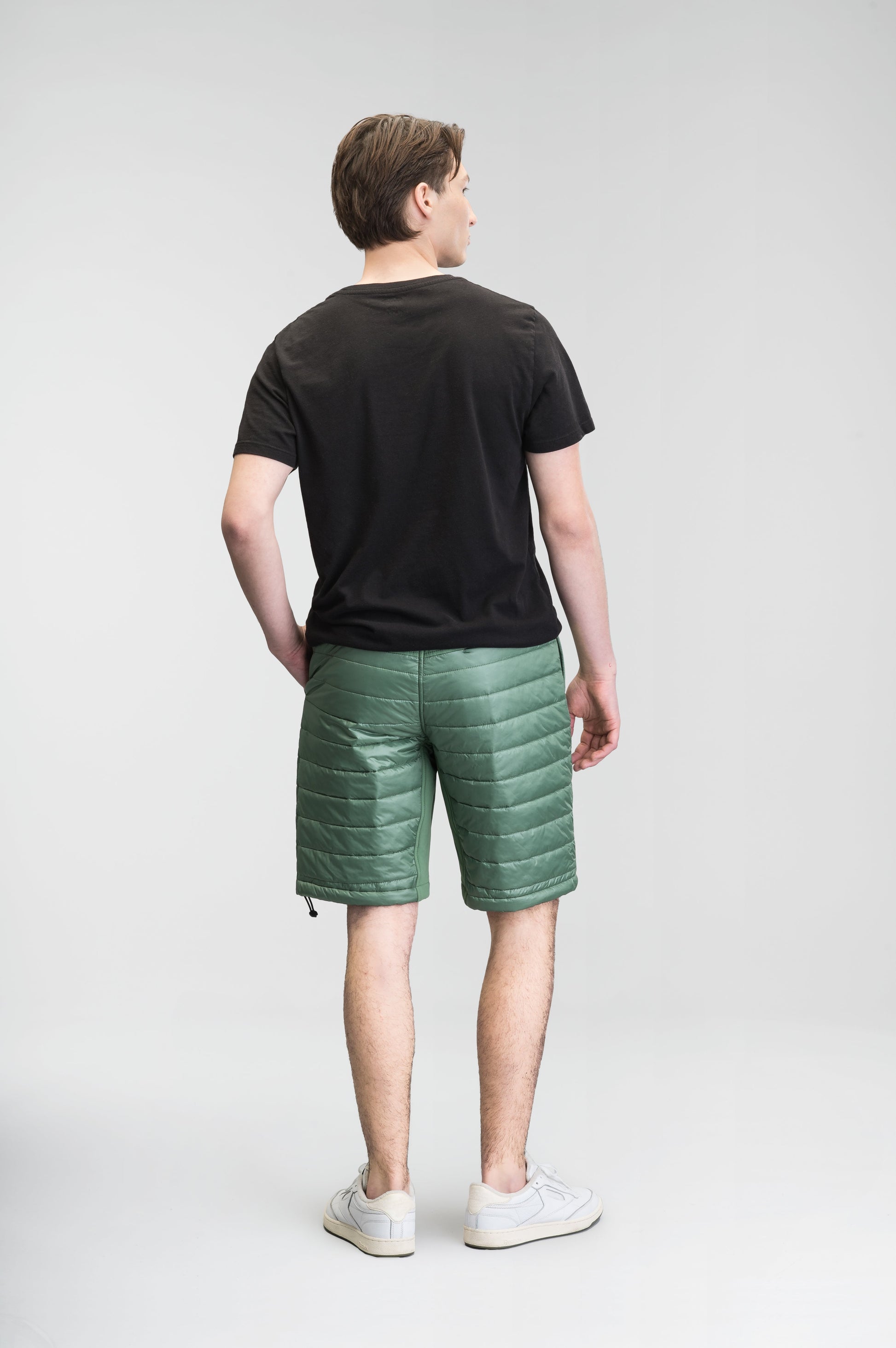 Decker Men's Performance Quilted Shorts in knee length, premium cire technical nylon taffeta and stretch nylon fabrication, premium 4-way stretch, water-resistant Primaloft Gold Insulation Active+, side seam pockets, invisible zipper back pokcet, elasticized waist with drawcords, and hidden drawcord at leg hems, in Comfrey