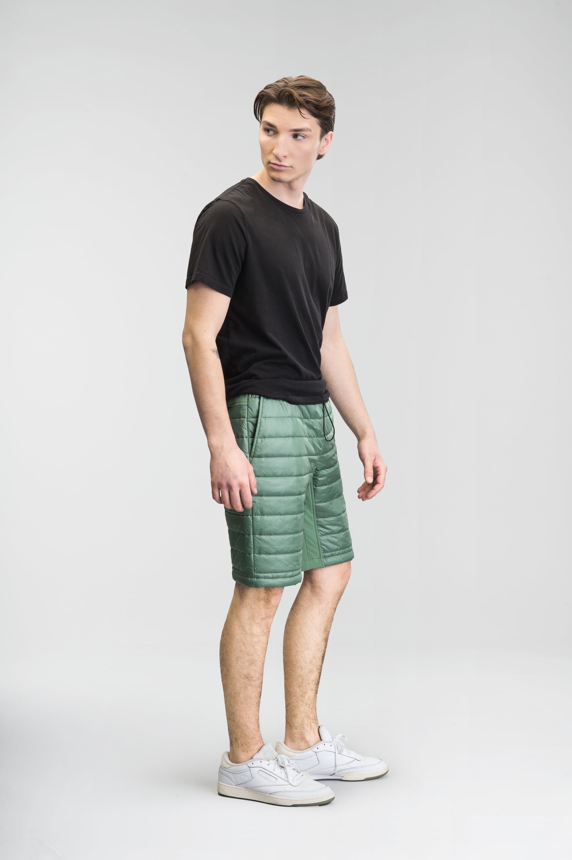 Decker Men's Performance Quilted Shorts in knee length, premium cire technical nylon taffeta and stretch nylon fabrication, premium 4-way stretch, water-resistant Primaloft Gold Insulation Active+, side seam pockets, invisible zipper back pokcet, elasticized waist with drawcords, and hidden drawcord at leg hems, in Comfrey