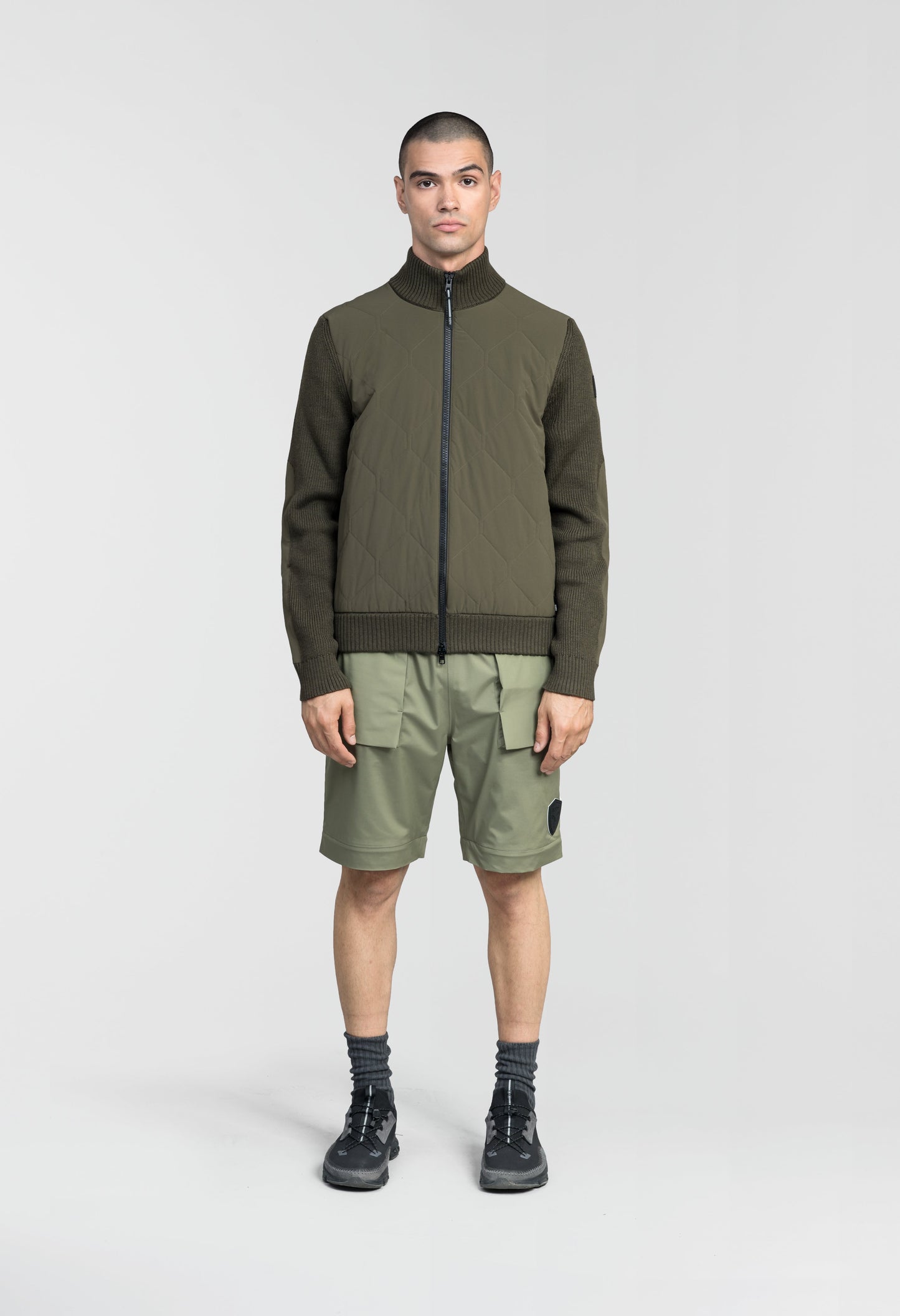 Ero Men's Tailored Hybrid Sweater in hip length, PrimaLoft Gold Insulation Active+, Durable 4-Way Stretch Weave quilted torso, Merino wool knit collar, sleeves, back, and cuffs, two-way front zipper, and hidden waist pockets, in Fatigue