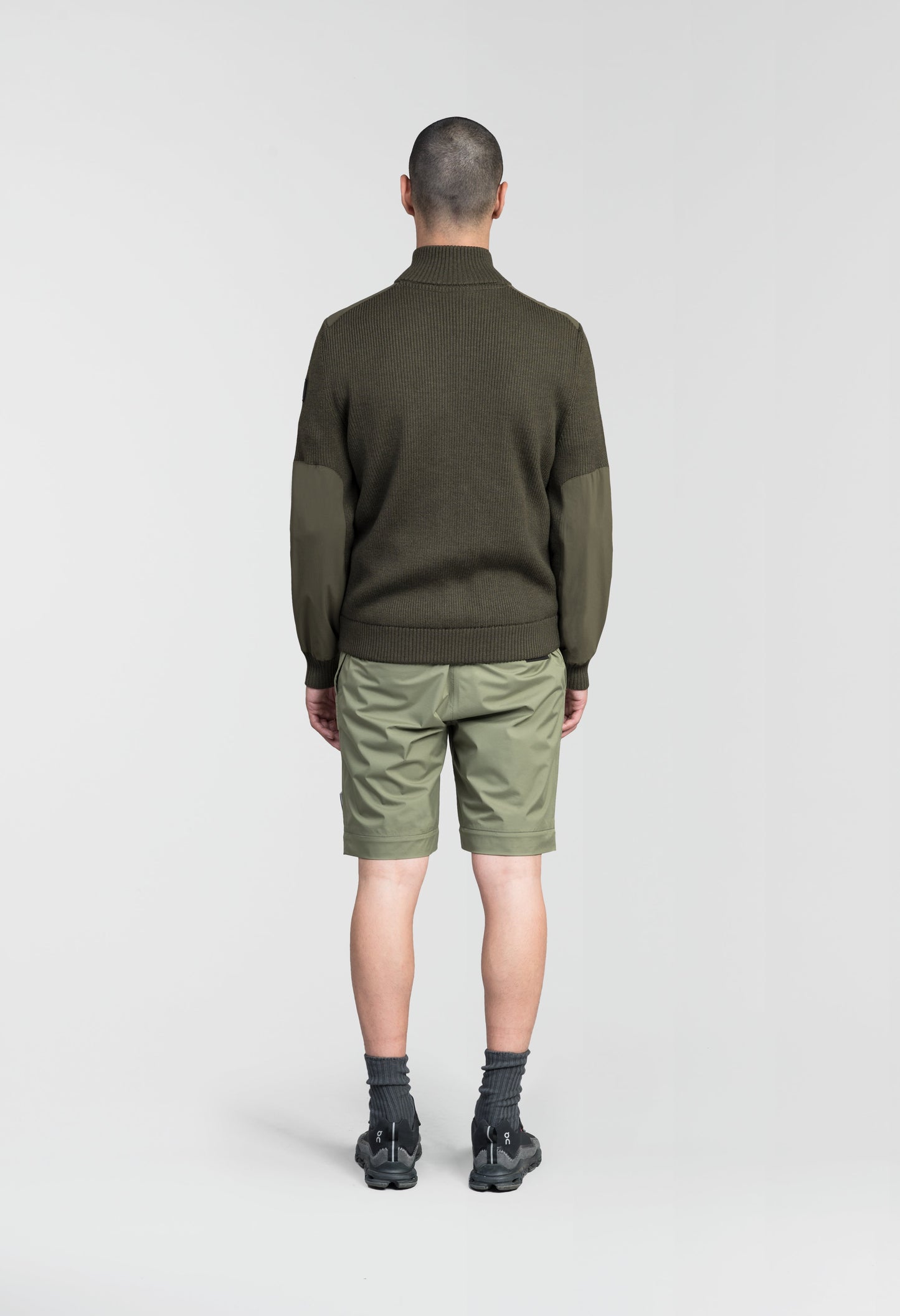 Ero Men's Tailored Hybrid Sweater in hip length, PrimaLoft Gold Insulation Active+, Durable 4-Way Stretch Weave quilted torso, Merino wool knit collar, sleeves, back, and cuffs, two-way front zipper, and hidden waist pockets, in Fatigue