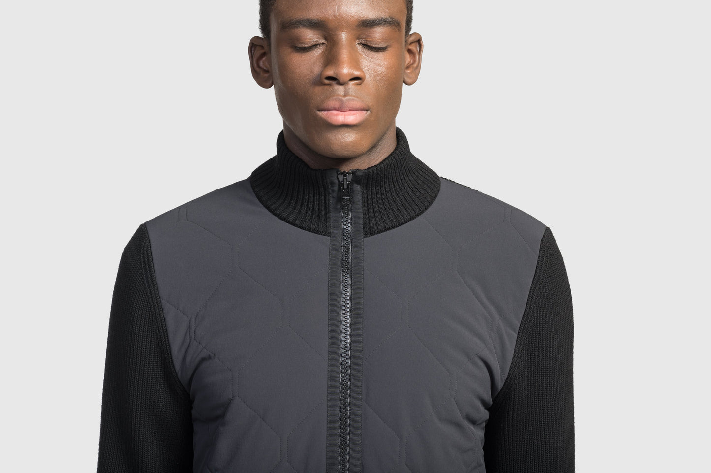 Ero Men's Tailored Hybrid Sweater in hip length, PrimaLoft Gold Insulation Active+, Durable 4-Way Stretch Weave quilted torso, Merino wool knit collar, sleeves, back, and cuffs, two-way front zipper, and hidden waist pockets, in Black