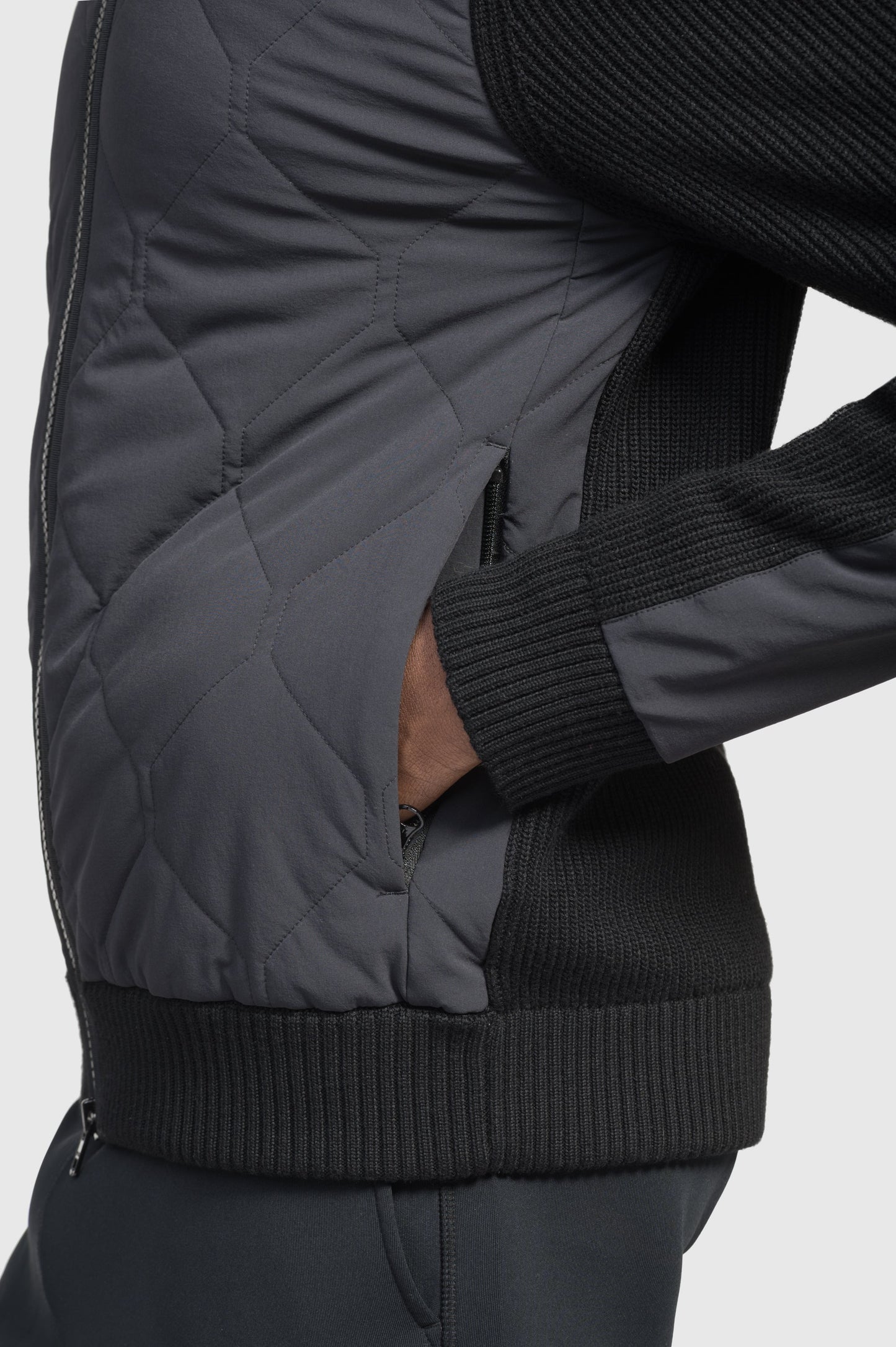 Ero Men's Tailored Hybrid Sweater in hip length, PrimaLoft Gold Insulation Active+, Durable 4-Way Stretch Weave quilted torso, Merino wool knit collar, sleeves, back, and cuffs, two-way front zipper, and hidden waist pockets, in Black