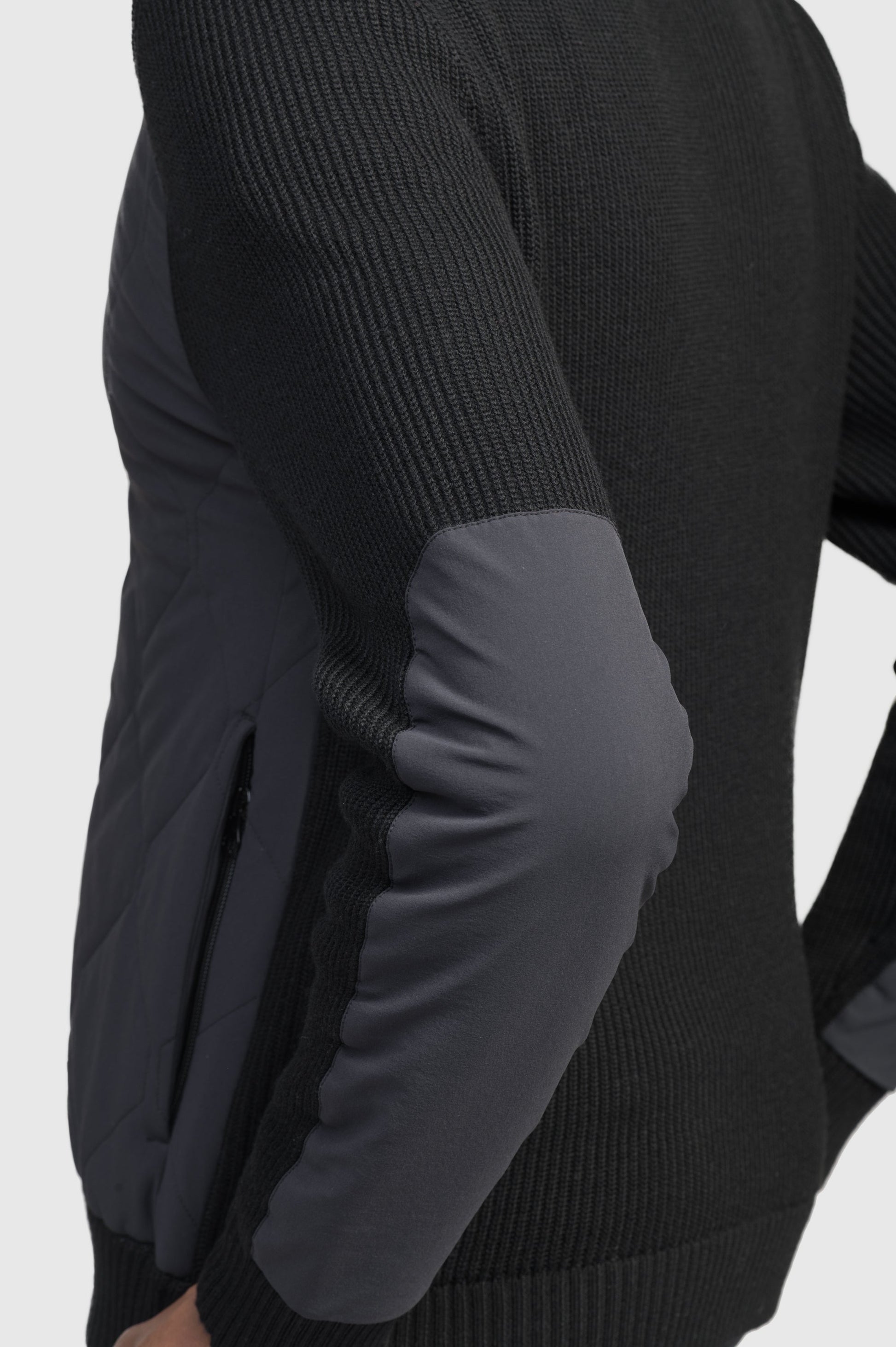 Ero Men's Tailored Hybrid Sweater in hip length, PrimaLoft Gold Insulation Active+, Durable 4-Way Stretch Weave quilted torso, Merino wool knit collar, sleeves, back, and cuffs, two-way front zipper, and hidden waist pockets, in Black