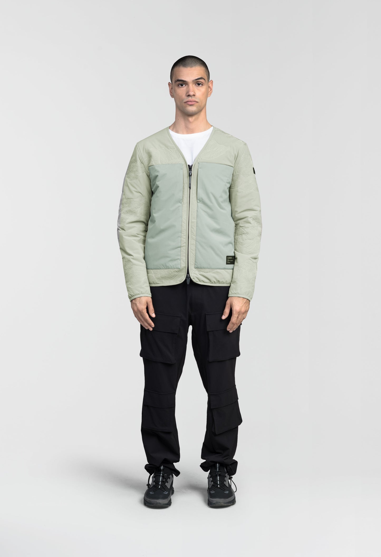 Gates Men's Performance Quilted V-Neck Jacket in hip length, centre front two-way zipper, hidden zipper chest pockets, side entry waist pockets, in Tea