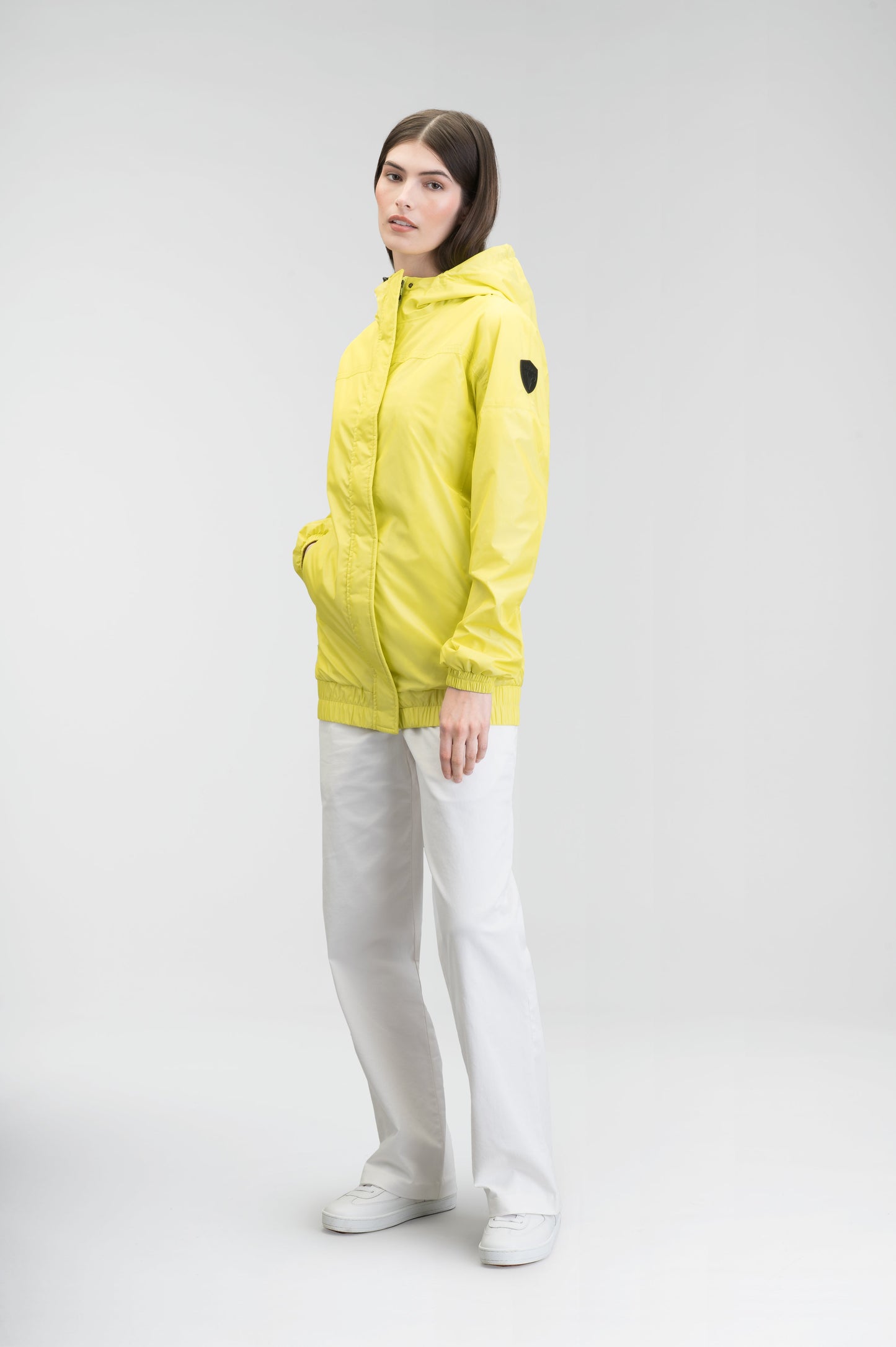 Hartley Women's Tailored Rain Jacket in hip length, two-way centre front zipper with wind flap, toggle adjustable cuffs and waist cord, non-removable hood, side entry waist pockets, in Sulphur Spring