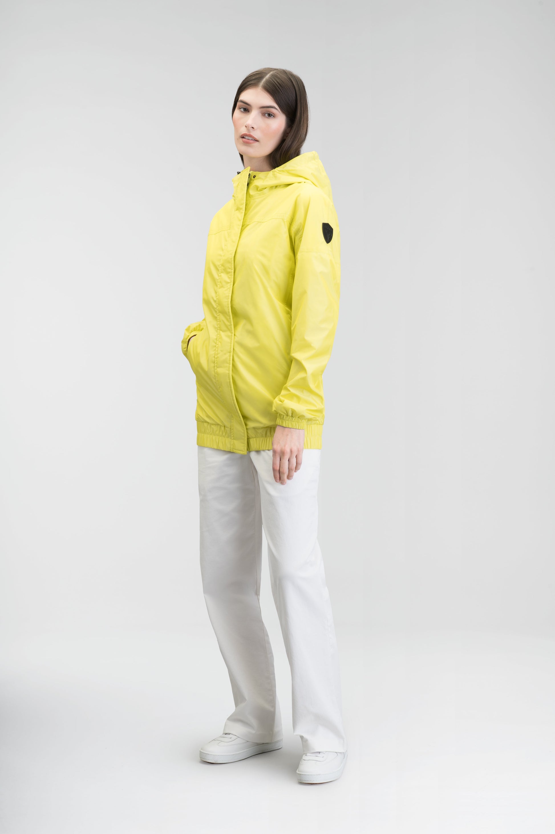 Hartley Women's Tailored Rain Jacket in hip length, two-way centre front zipper with wind flap, toggle adjustable cuffs and waist cord, non-removable hood, side entry waist pockets, in Sulphur Spring