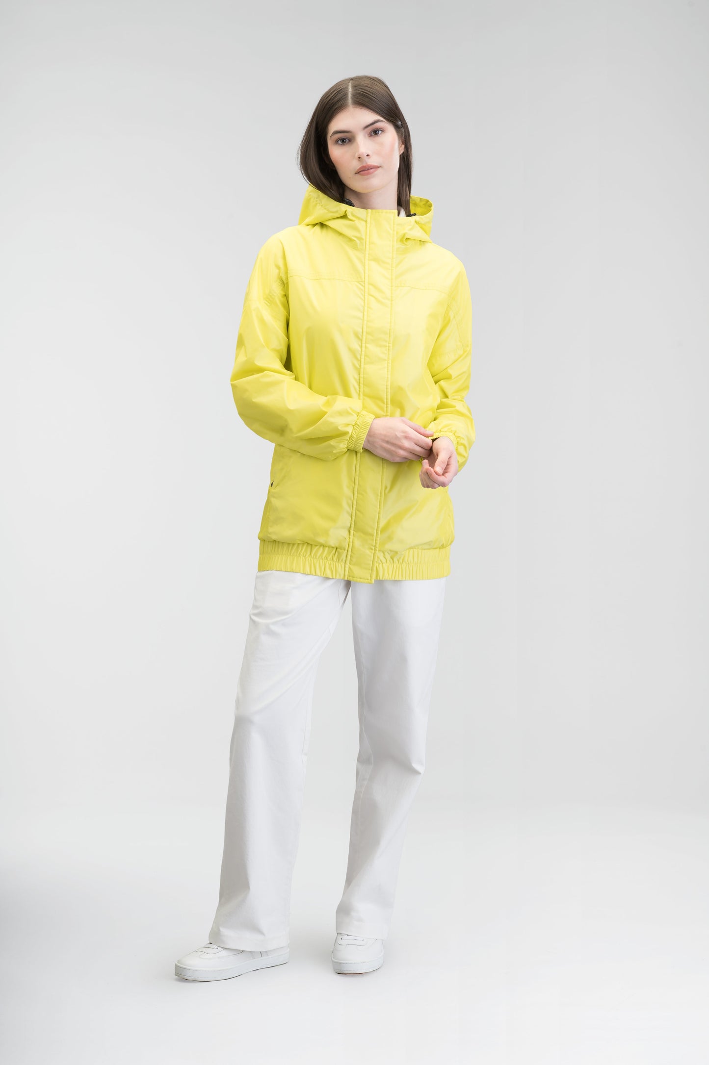 Hartley Women's Tailored Rain Jacket in hip length, two-way centre front zipper with wind flap, toggle adjustable cuffs and waist cord, non-removable hood, side entry waist pockets, in Sulphur Spring