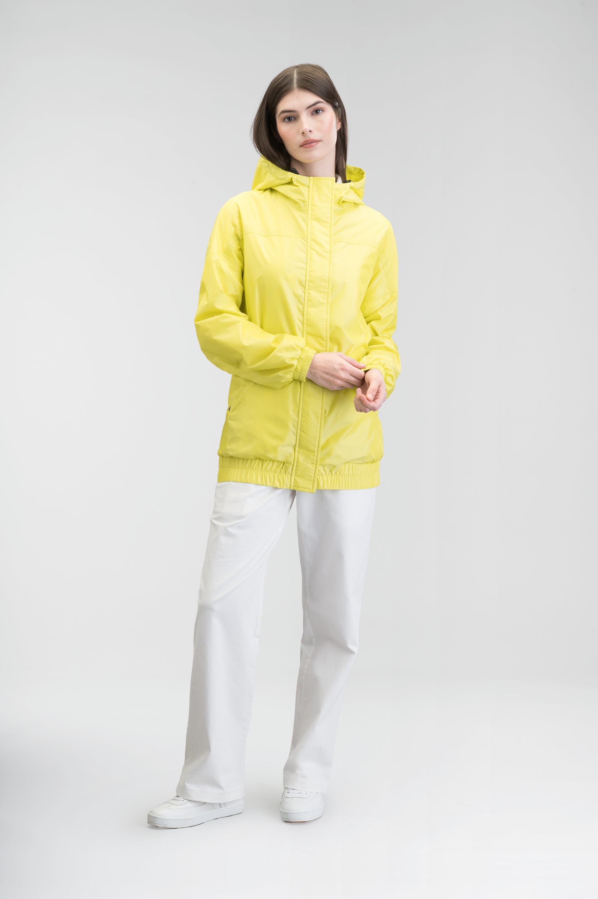 Hartley Women's Tailored Rain Jacket in hip length, two-way centre front zipper with wind flap, toggle adjustable cuffs and waist cord, non-removable hood, side entry waist pockets, in Sulphur Spring