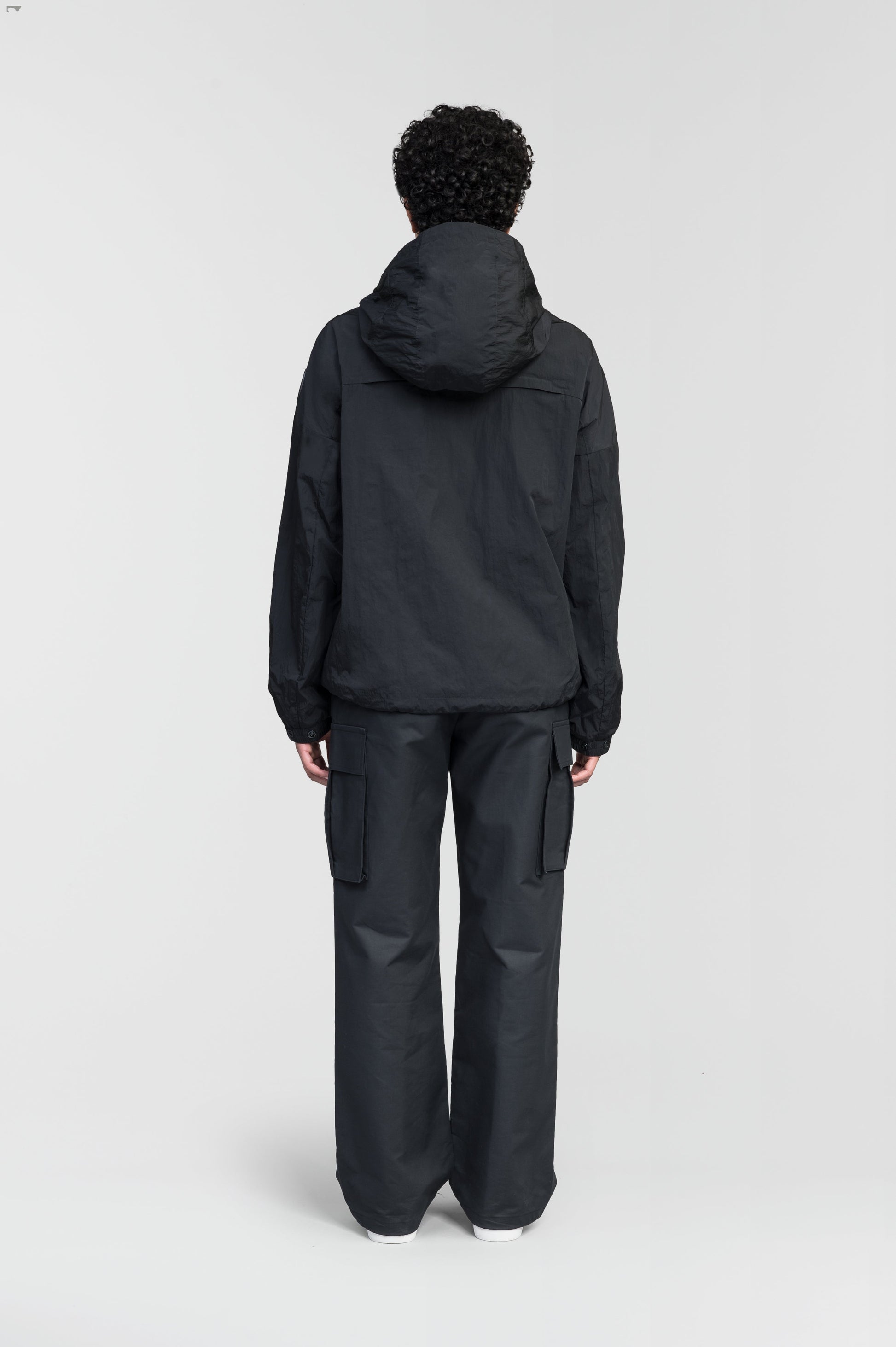 Hartley Women's Tailored Rain Jacket in hip length, two-way centre front zipper with wind flap, toggle adjustable cuffs and waist cord, non-removable hood, side entry waist pockets, in Black