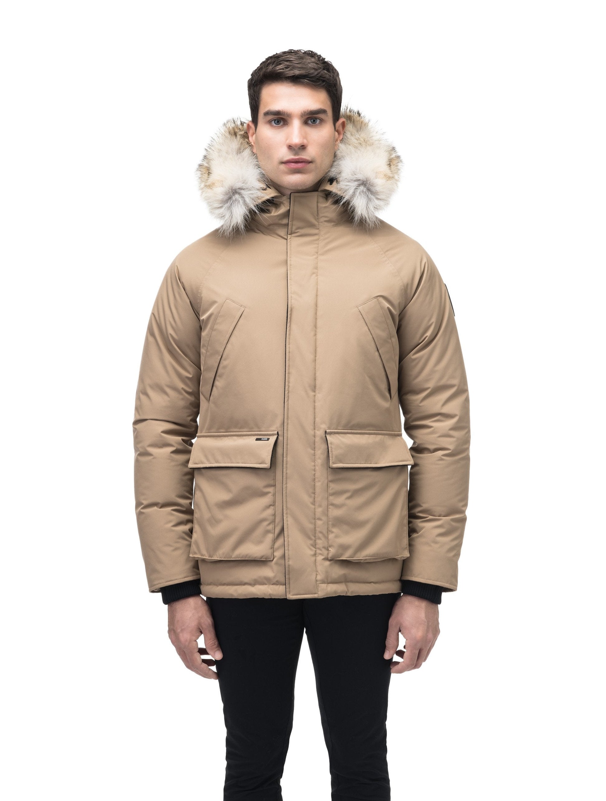 Men's waist length down filled jacket with two front pockets with magnetic closure and a removable fur trim on the hood in Cork