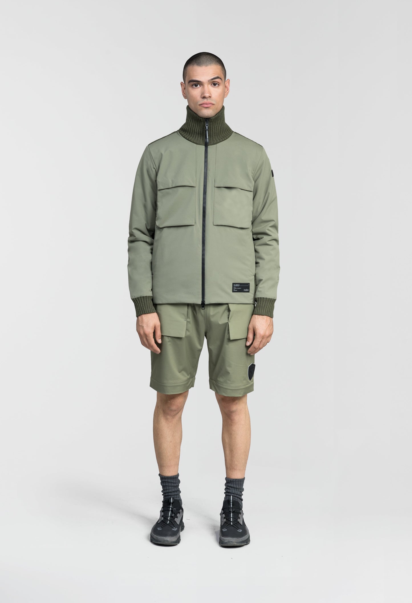 Layton Men's Tactical Hybrid Sweater in hip length, Primaloft Gold Insulation Active+, Merion wool knit collar, sleeves, back, and cuffs, two-way front zipper, and pockets at chest and waist, in Clover