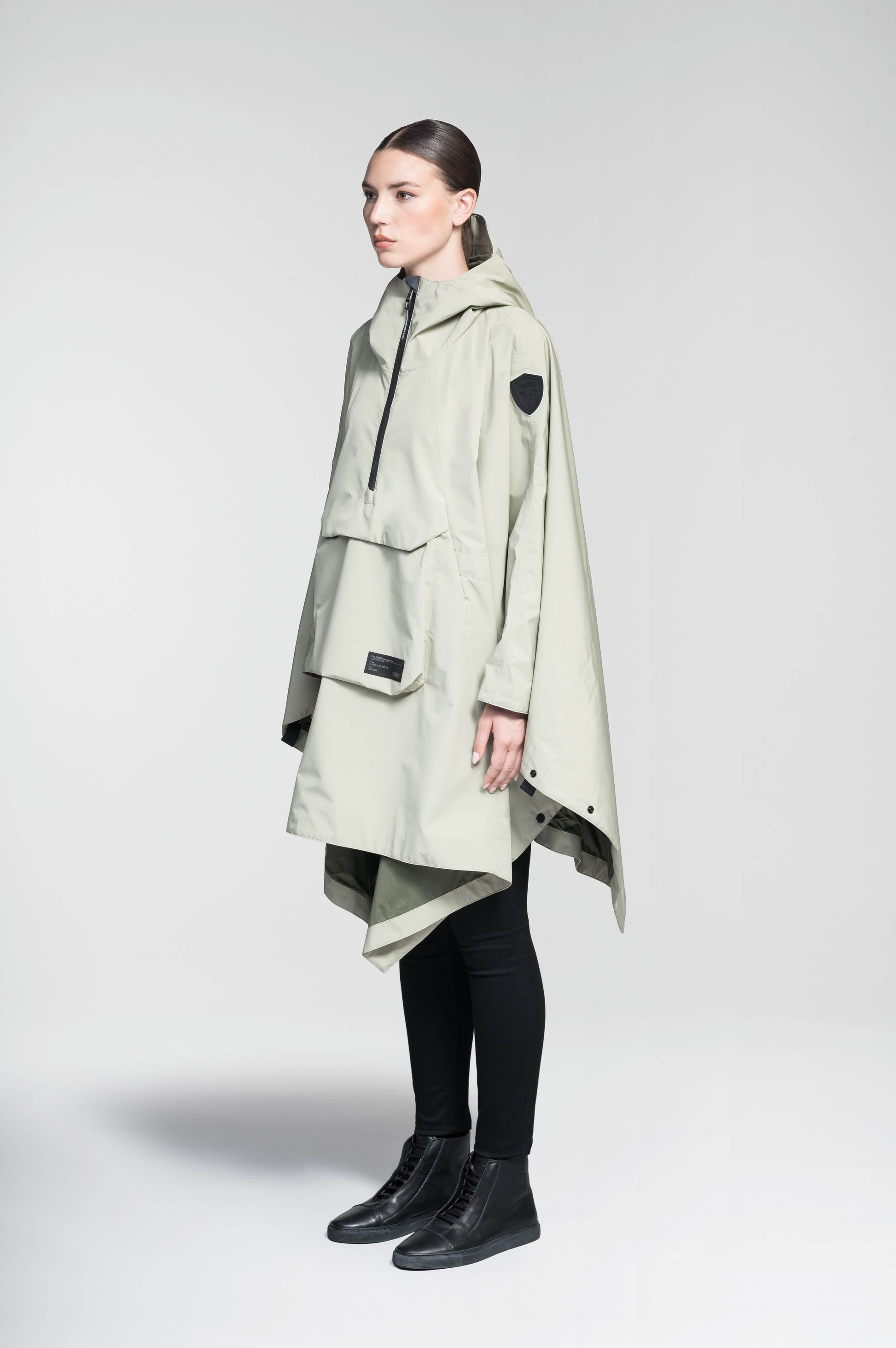 Hydra Unisex Performance Poncho in thigh length, non-removable hood, vertical half-zipper along centre front collar, hidden side-entry waist zipper pockets, adjustable webbing straps and snap closure cuffs, and packable to front kangaroo pocket with flap opening, in Tea