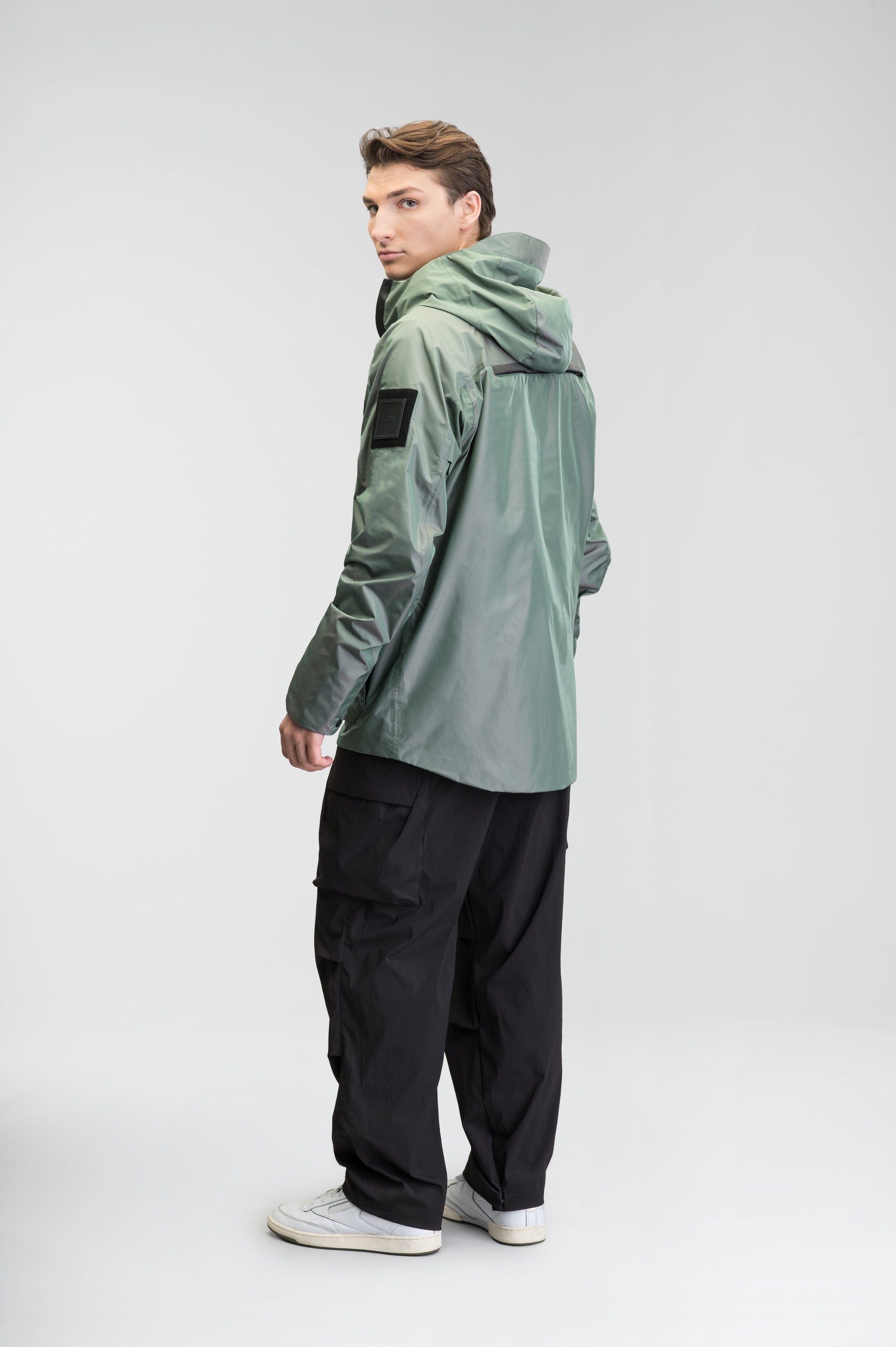 Mission Men's Performance Rain Shell Jacket in hip length, non-removable hood with adjustable toggle, two-way waterproof zipper, flap closure waist pockets with additional side entry storage, zipper ventilation on back, passive underarm ventilation, and breathable mesh lining, in Duck Green