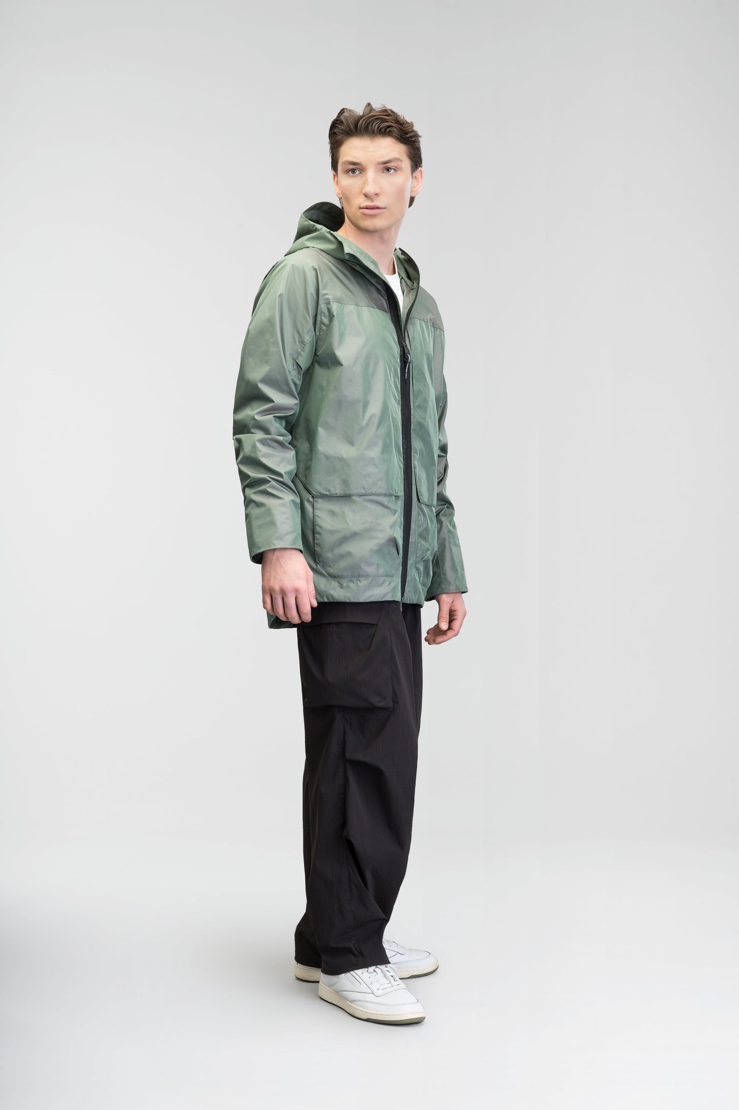 Mission Men's Performance Rain Shell Jacket in hip length, non-removable hood with adjustable toggle, two-way waterproof zipper, flap closure waist pockets with additional side entry storage, zipper ventilation on back, passive underarm ventilation, and breathable mesh lining, in Duck Green