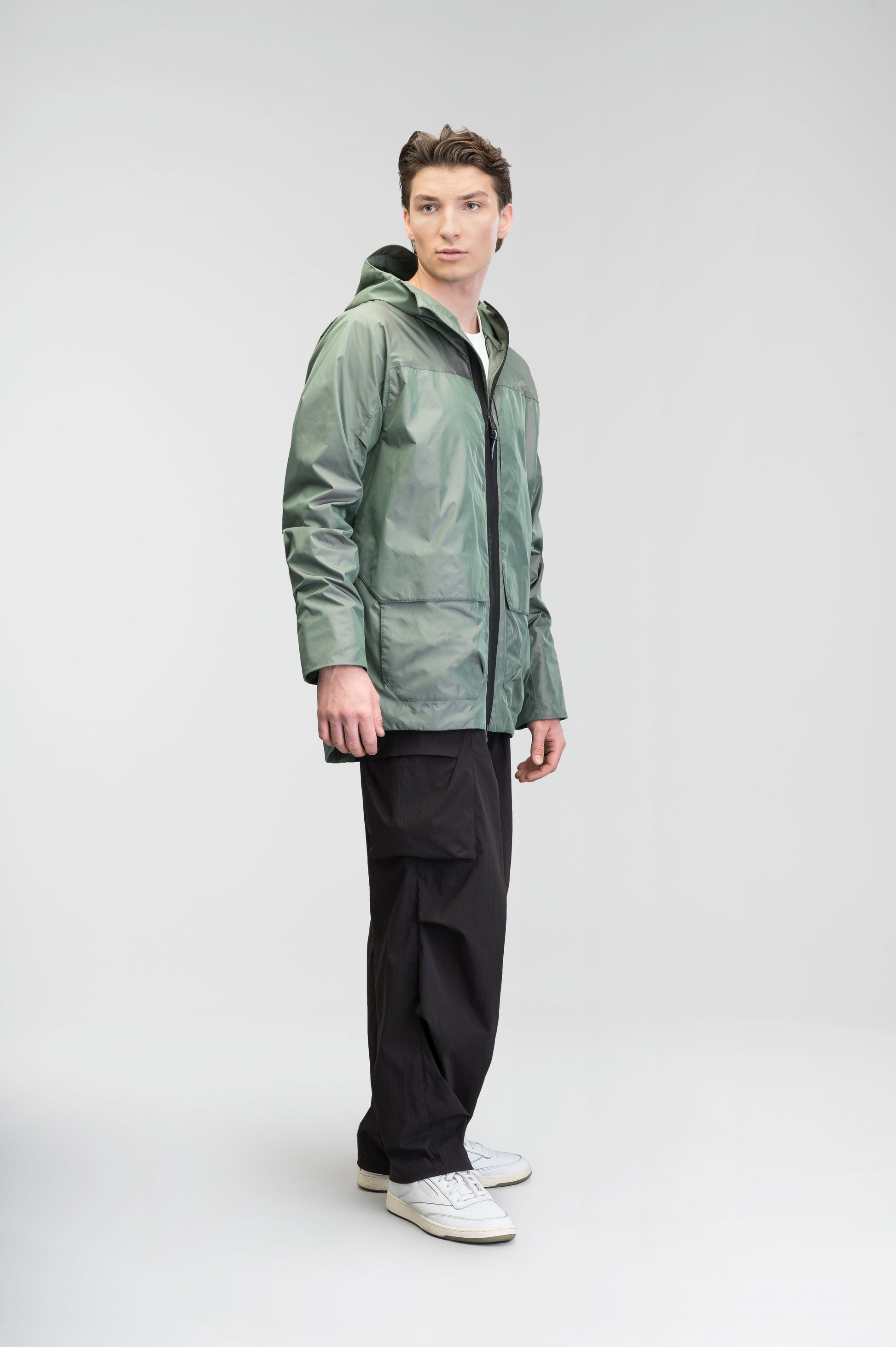 Mission Men's Performance Rain Shell Jacket in hip length, non-removable hood with adjustable toggle, two-way waterproof zipper, flap closure waist pockets with additional side entry storage, zipper ventilation on back, passive underarm ventilation, and breathable mesh lining, in Duck Green