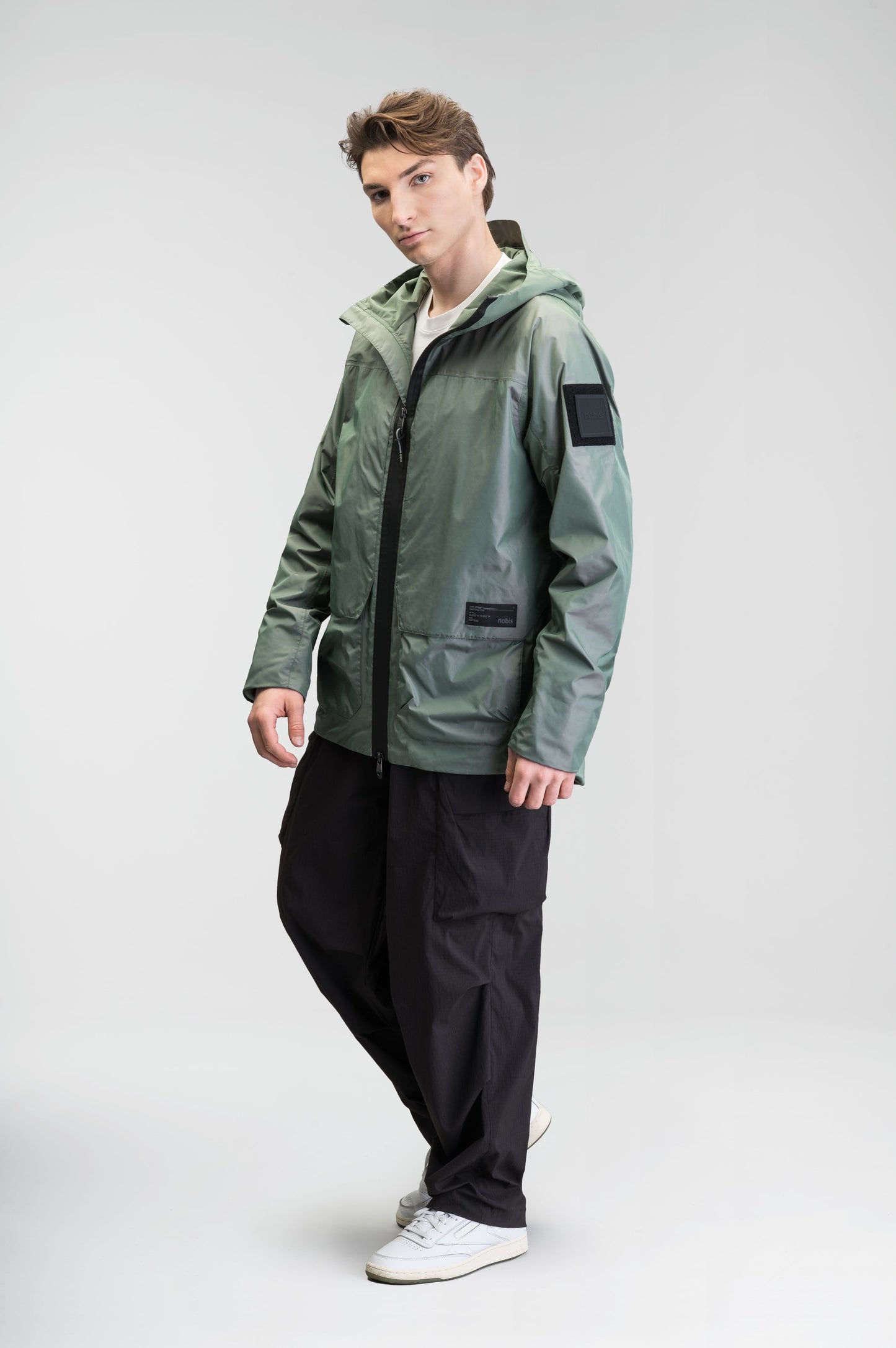 Mission Men's Performance Rain Shell Jacket in hip length, non-removable hood with adjustable toggle, two-way waterproof zipper, flap closure waist pockets with additional side entry storage, zipper ventilation on back, passive underarm ventilation, and breathable mesh lining, in Duck Green