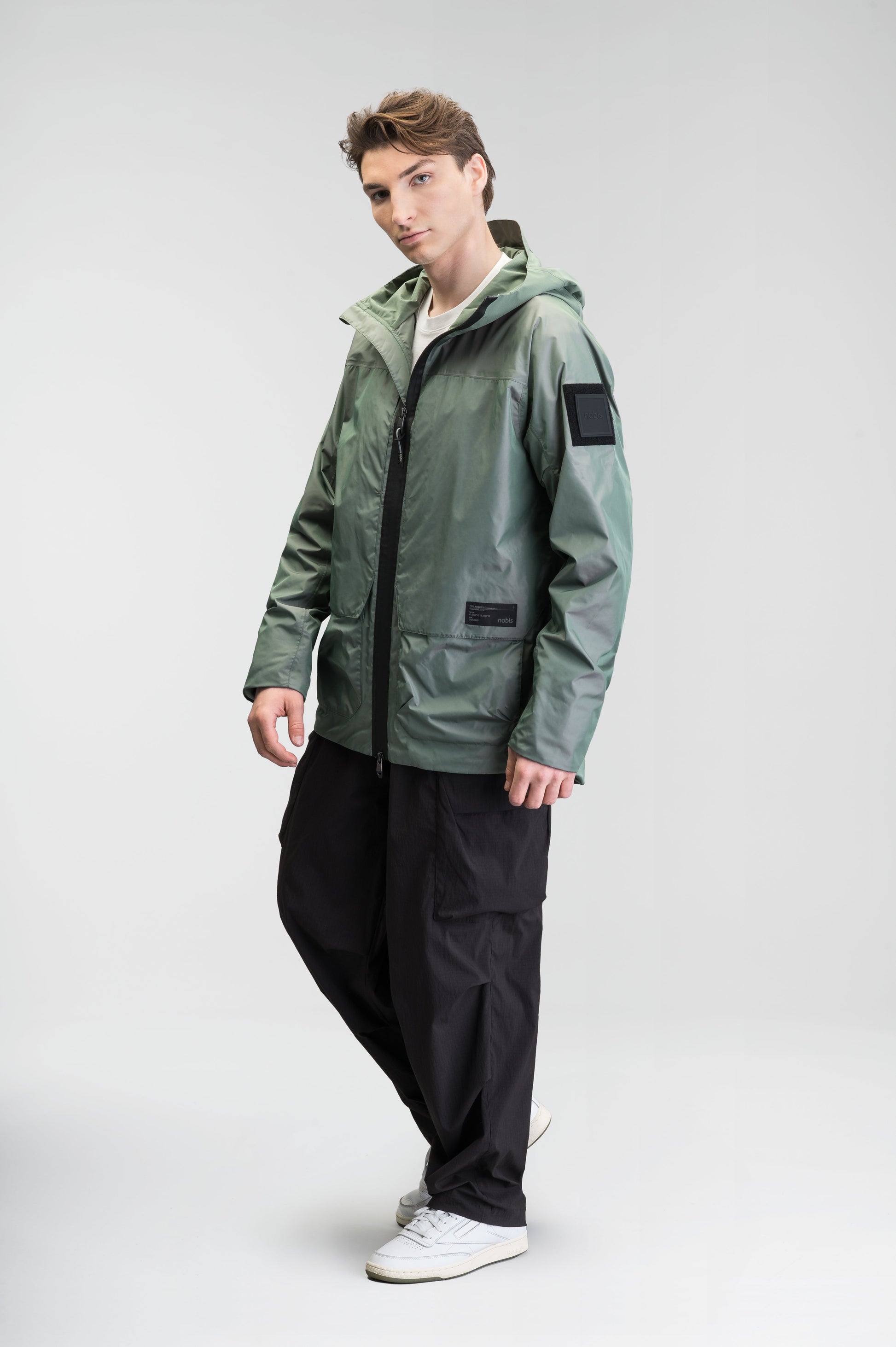 Mission Men's Performance Rain Shell Jacket in hip length, non-removable hood with adjustable toggle, two-way waterproof zipper, flap closure waist pockets with additional side entry storage, zipper ventilation on back, passive underarm ventilation, and breathable mesh lining, in Duck Green