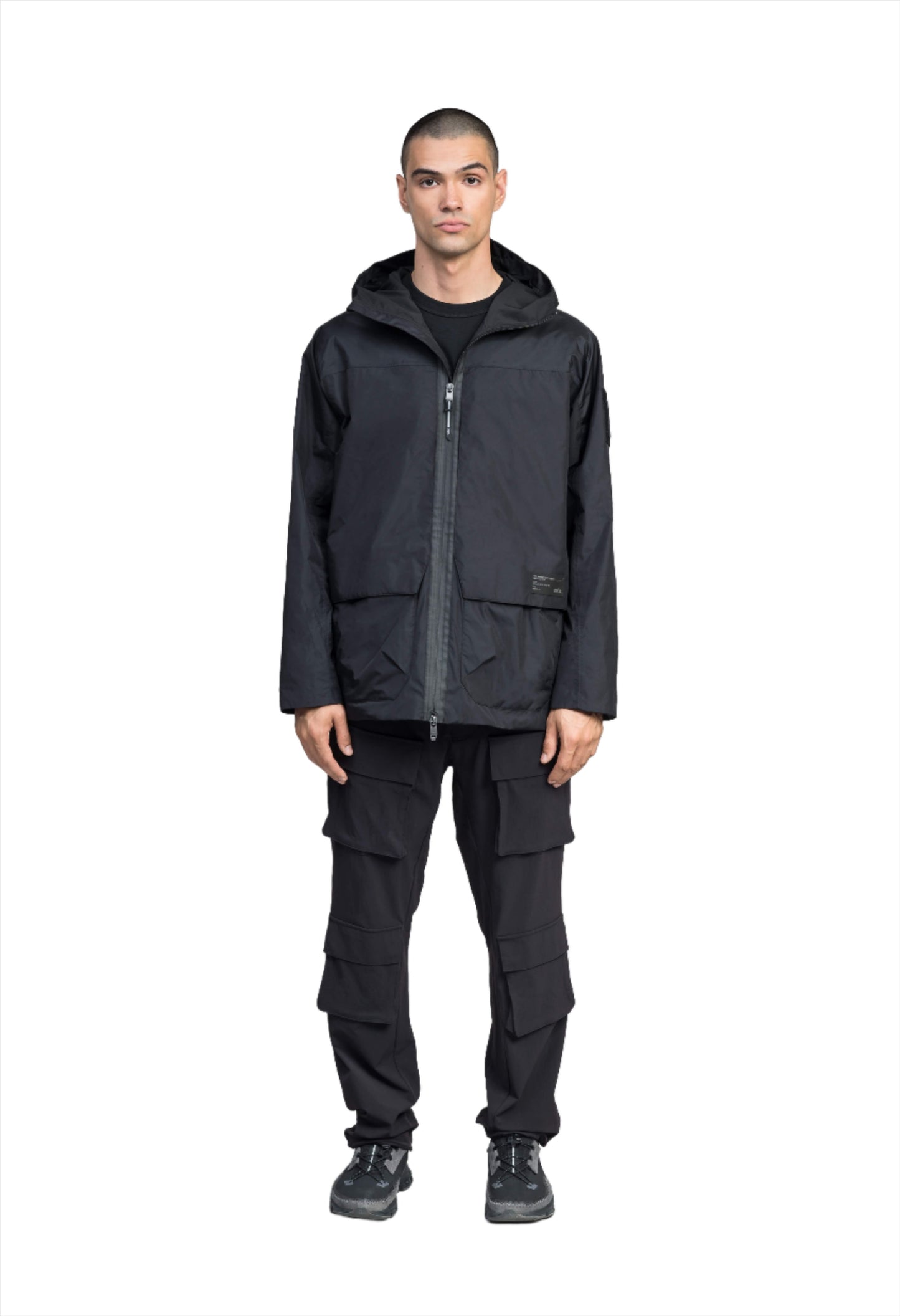 Mission Men's Performance Rain Shell Jacket in hip length, non-removable hood with adjustable toggle, two-way waterproof zipper, flap closure waist pockets with additional side entry storage, zipper ventilation on back, passive underarm ventilation, and breathable mesh lining, in Black