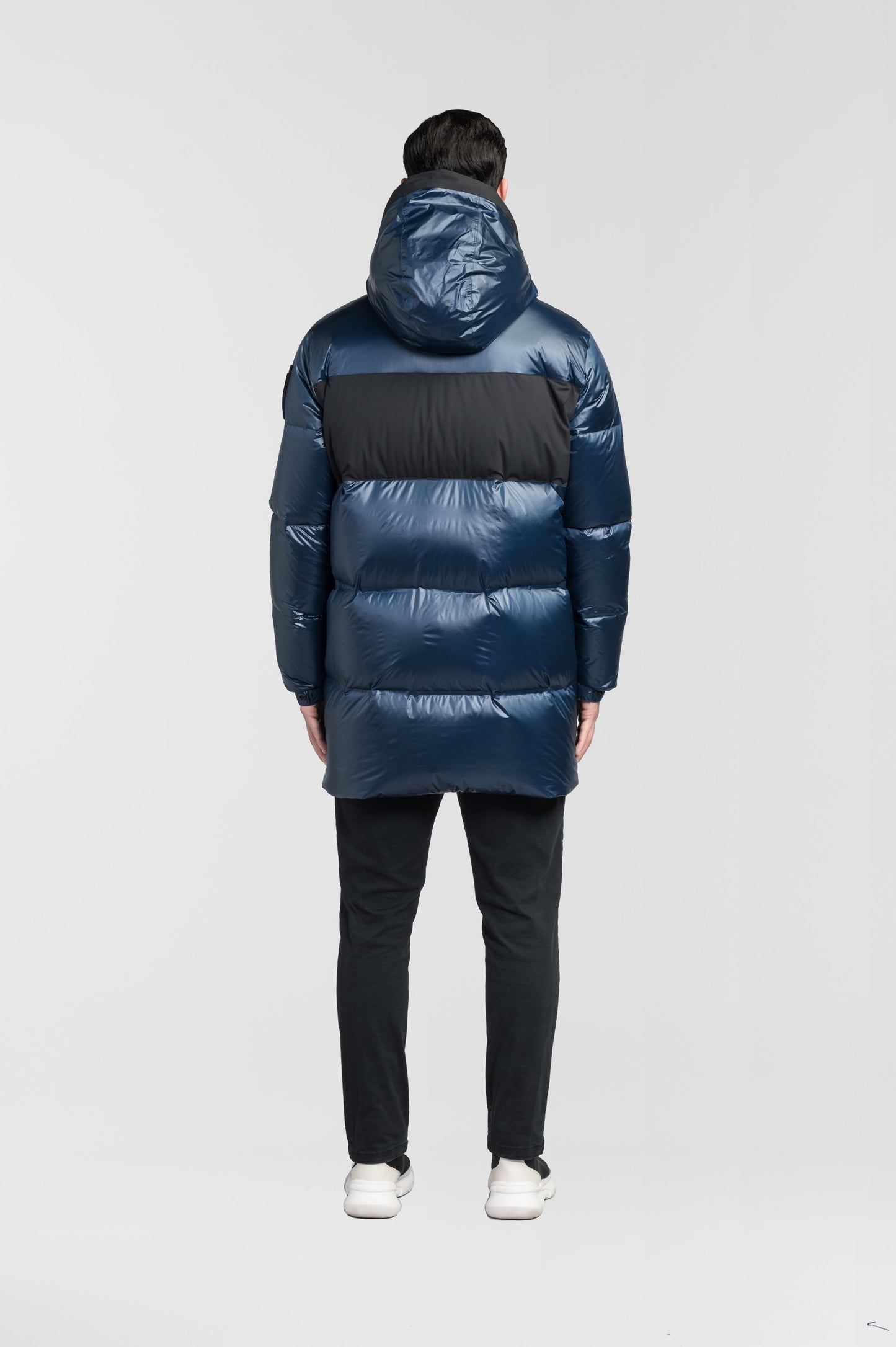 Neelix Men's Long Puffer Jacket in thigh length, premium cire technical nylon taffeta and stretch ripstop fabrication, Premium Canadian origin White Duck Down insulation, non-removable down-filled hood, two-way centre-front zipper, pit zipper vents, hidden chest zipper pockets, fleece-lined magnetic closure waist pockets, in Marine