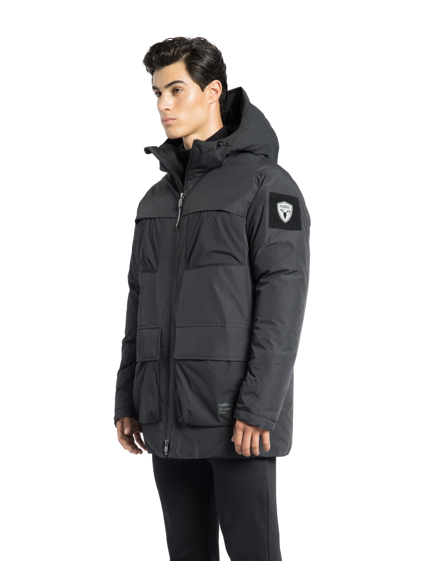 Ronin Men's Performance Utility Jacket in thigh length, premium 3-ply micro denier and stretch ripstop fabrication, Premium Canadian origin White Duck Down insulation, non-removable down-filled hood, bellow chest pockets, magnetic closure waist flap pockets, two-way centre-front zipper, pit zipper vents, hidden adjustable waist drawcord, in Black