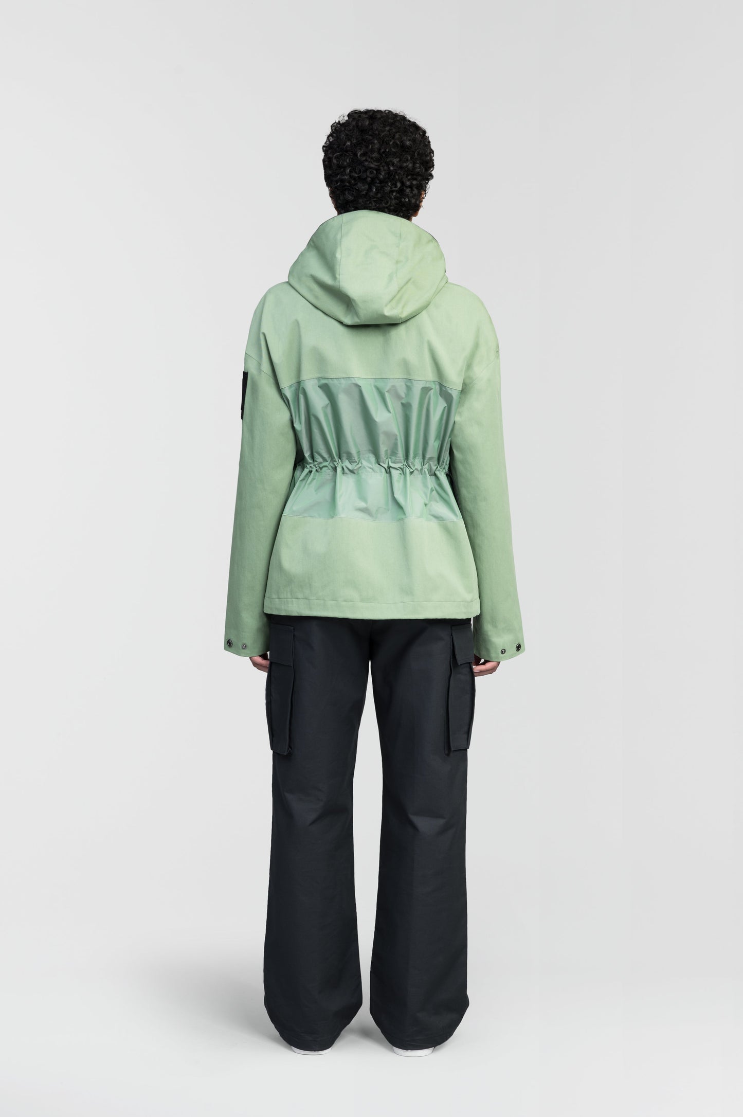 Opal Women's Performance Short Shell Jacket in hip length, premium cotton blend and contrast iridescent fabrication, adjustable drawcord at waist, non-removable hood with reflective trim, adjustable hood draw cord at interior collar, zippered side entry pockets at waist, top entry flap pockets at waist, adjustable snap cuffs, snap button wind flap, two-way branded zipper at centre front, and interior zipper pocket, in Comfrey