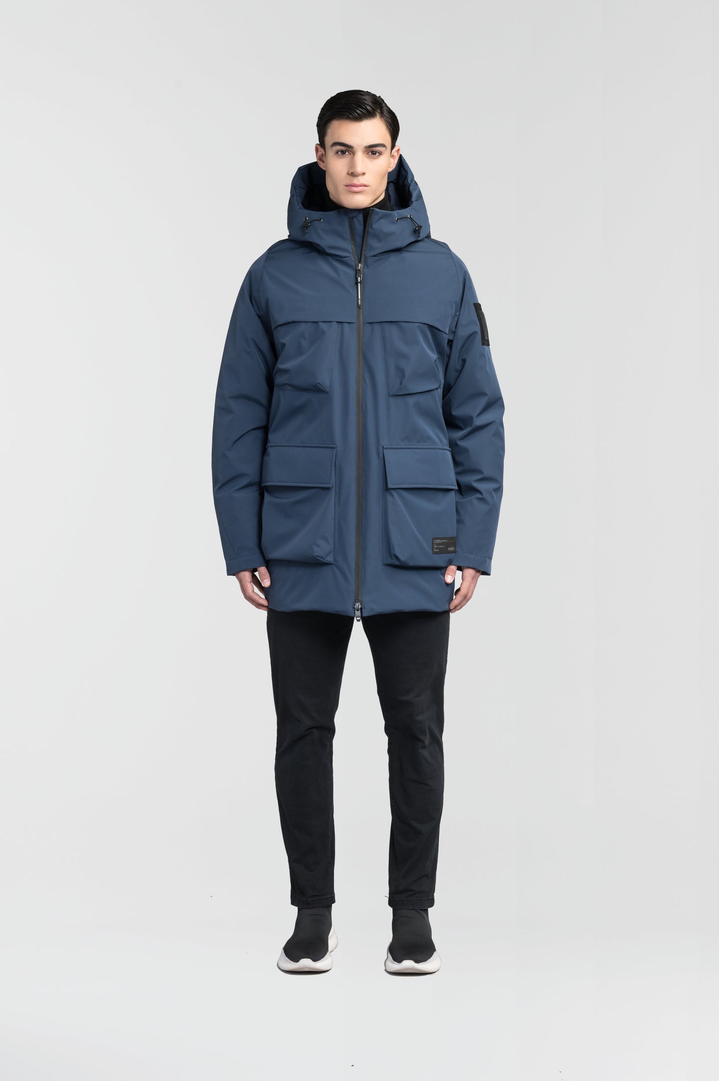 Ronin Men's Performance Utility Jacket in thigh length, premium 3-ply micro denier and stretch ripstop fabrication, Premium Canadian origin White Duck Down insulation, non-removable down-filled hood, bellow chest pockets, magnetic closure waist flap pockets, two-way centre-front zipper, pit zipper vents, hidden adjustable waist drawcord, in Marine