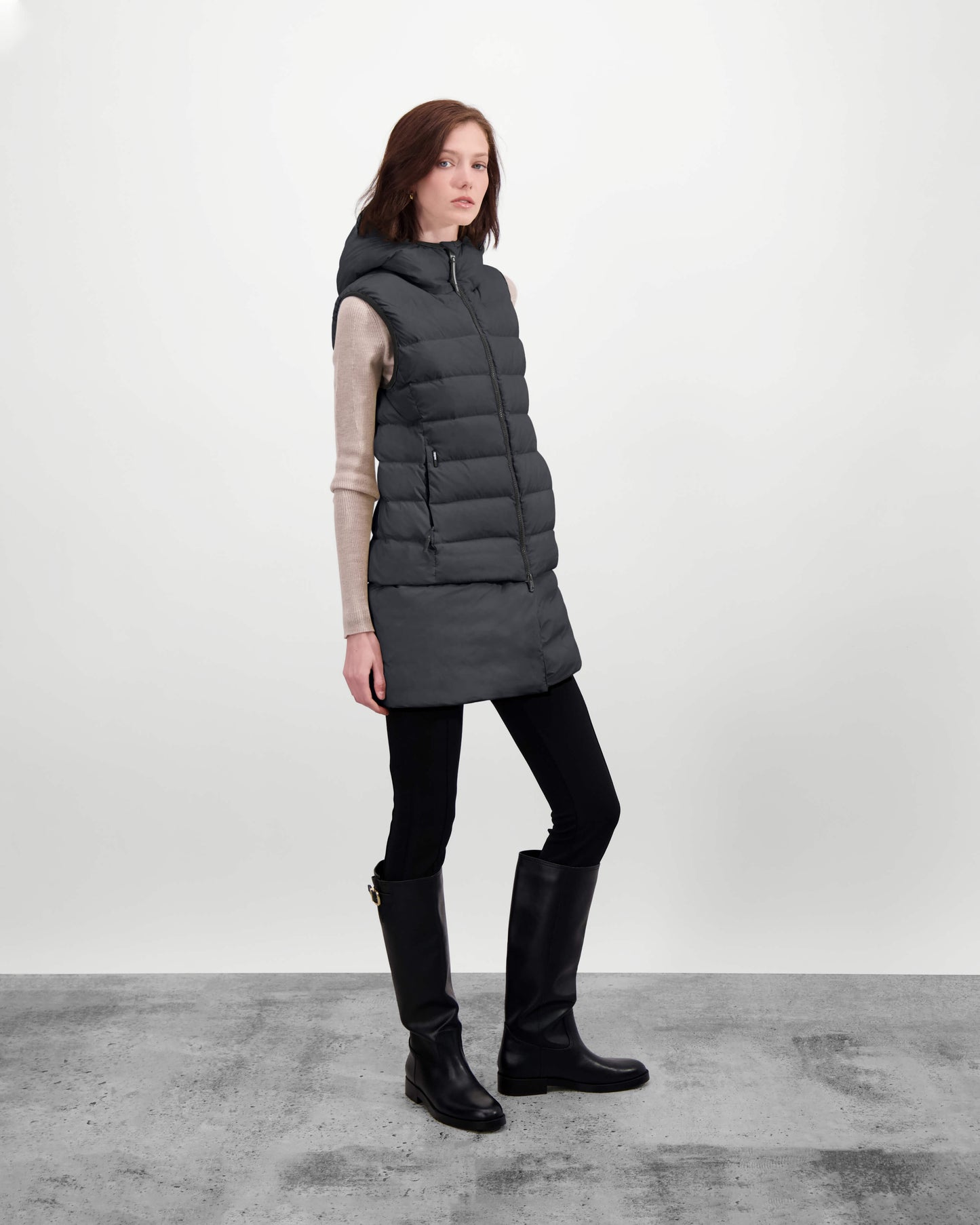 Saratoga puffer vest in Black insulated with Canadian white duck down, featuring stretch nylon ribbing for mobility, hidden waist drawcord, and a tailored fit for warmth and style. Lightweight and ideal for layering.