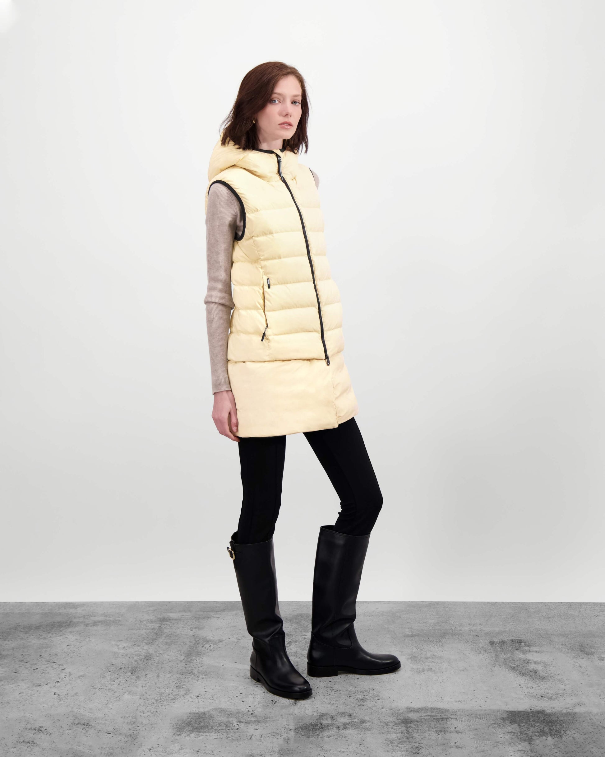 Saratoga puffer vest in Wheat insulated with Canadian white duck down, featuring stretch nylon ribbing for mobility, hidden waist drawcord, and a tailored fit for warmth and style. Lightweight and ideal for layering.