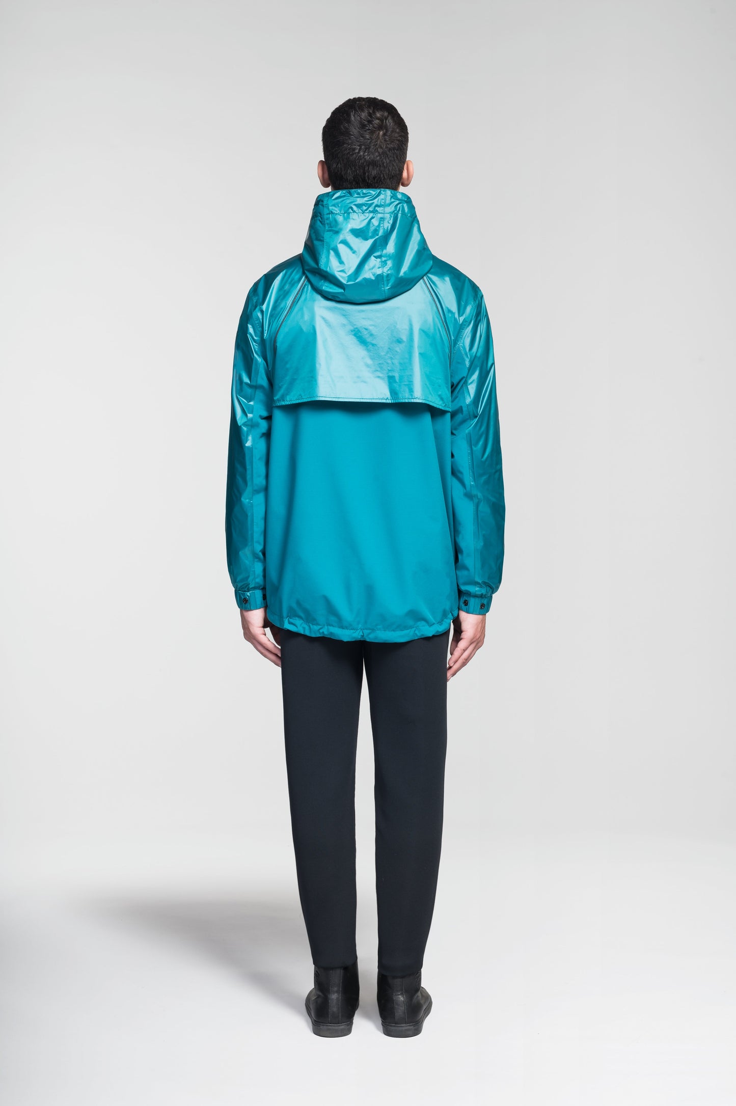 Stratus Men's Tailored Packable Rain Jacket in hip length, premium cire technical nylon taffeta and stretch ripstop fabrication, highly breathable mesh lining, hidden packable pocket, non-removable hood with adjustable draw cord, reflective piping along front and back, underarm grommets for extra breathability, back yoke with mesh ventilation, two waist zipper pockets, two interior zipper pockets, elastic cuffs with adjustable snap button, and adjustable interior draw cord at waist hem, in Deep Lake