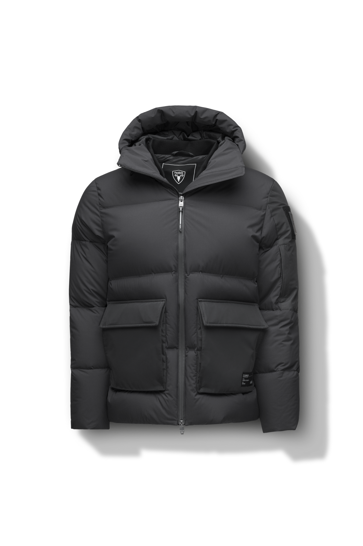 Supra Men's Performance Puffer in hip length, Technical Taffeta and 3-Ply Micro Denier fabrication, Premium Canadian White Duck Down insulation, non-removable down filled hood, centre front two-way zipper, flap pockets at waist, and zipper pocket at left bicep, in Black