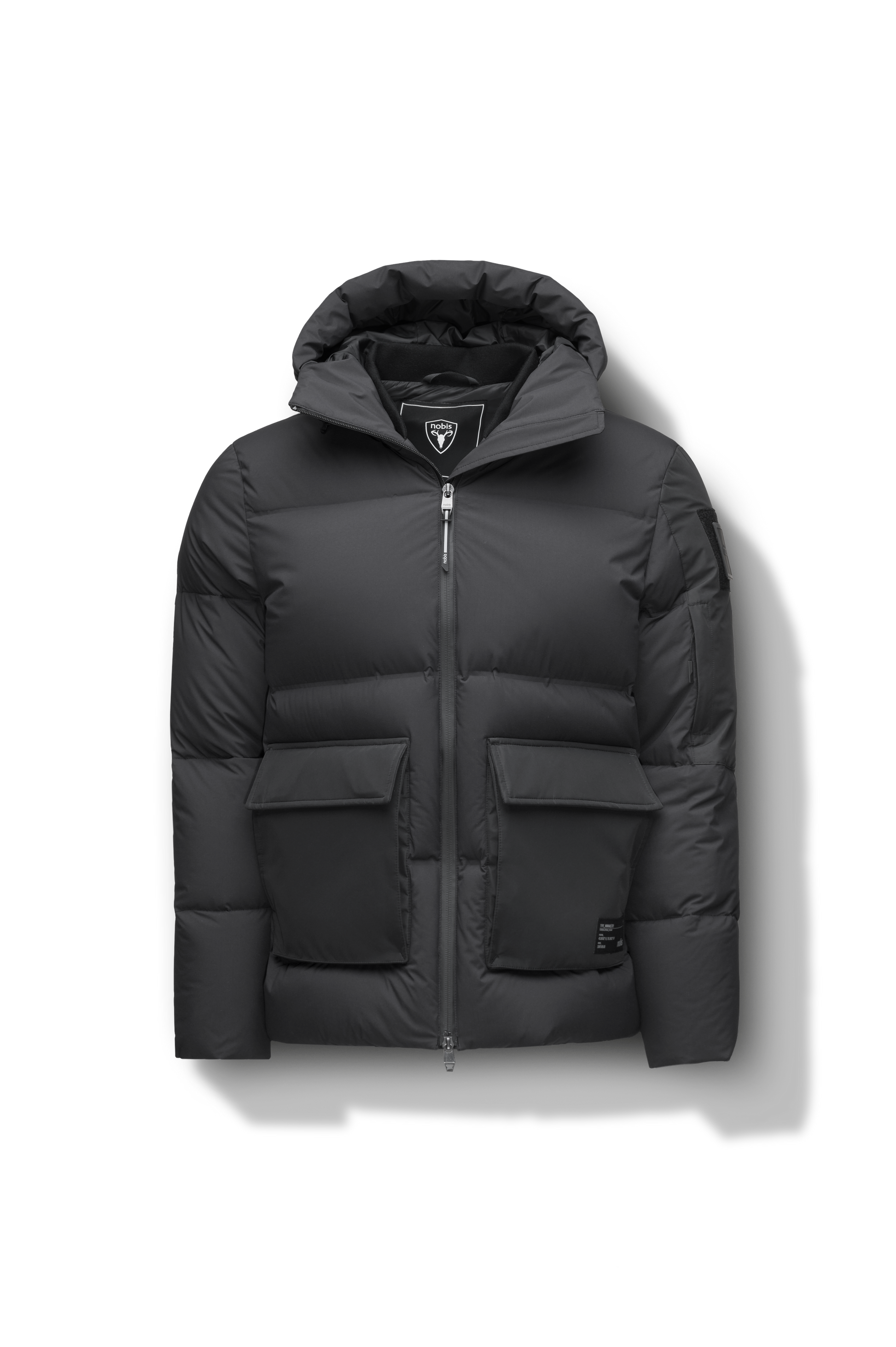 Supra Men's Performance Puffer in hip length, Technical Taffeta and 3-Ply Micro Denier fabrication, Premium Canadian White Duck Down insulation, non-removable down filled hood, centre front two-way zipper, flap pockets at waist, and zipper pocket at left bicep, in Black