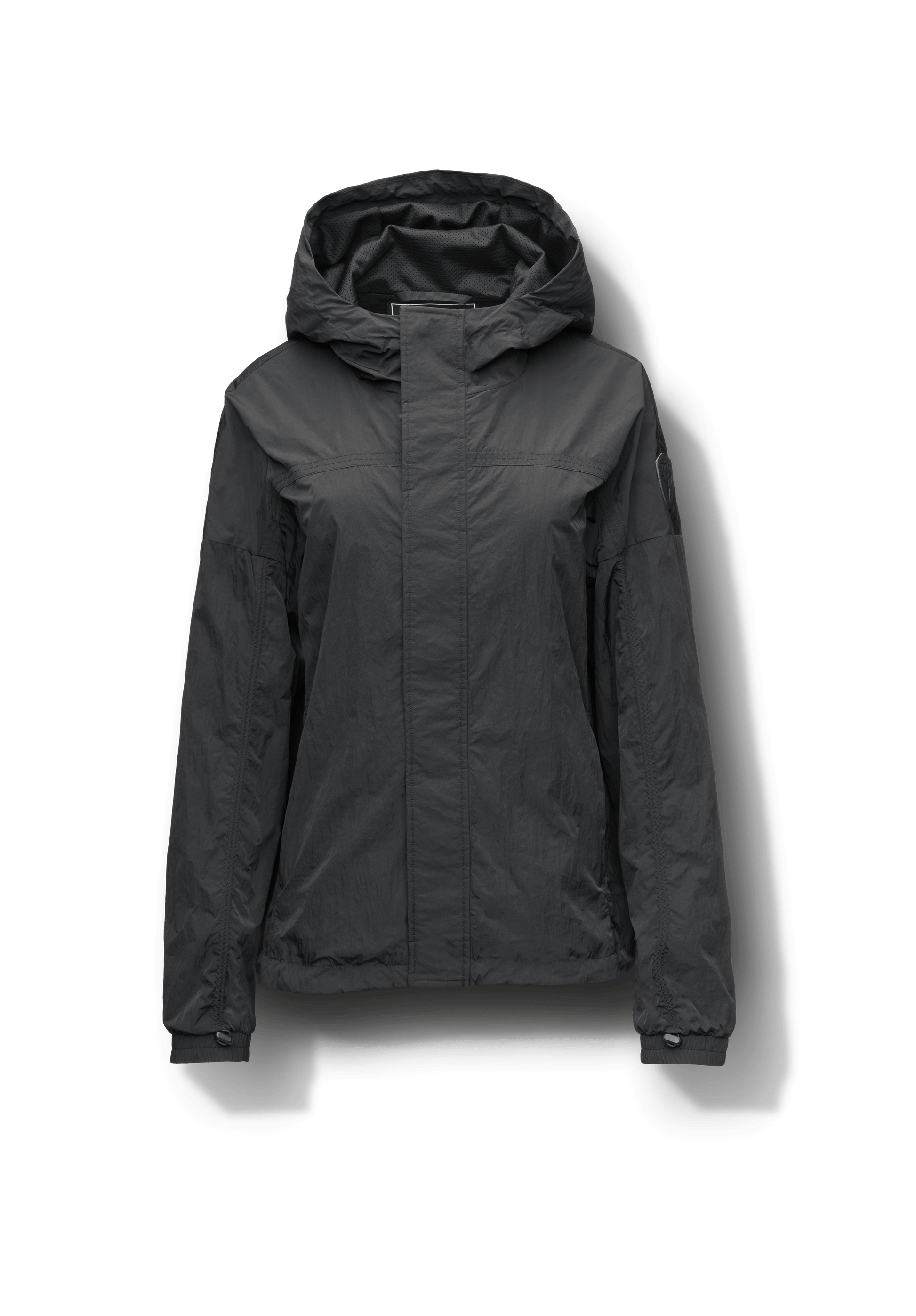 Hartley Women's Tailored Rain Jacket in hip length, two-way centre front zipper with wind flap, toggle adjustable cuffs and waist cord, non-removable hood, side entry waist pockets, in Black