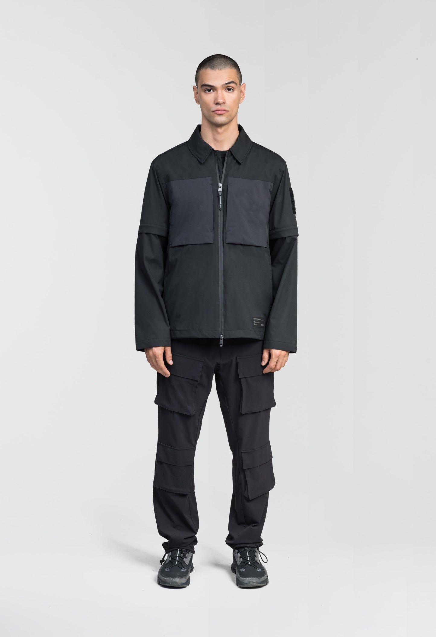 Thurlow Men's Performance Zip Off Sleeve Rain Shirt in hip length, convertible collar, patch chest zipper pockets, hidden in-seam pockets, zip off sleeves, centre front two-way zipper closure, in Black